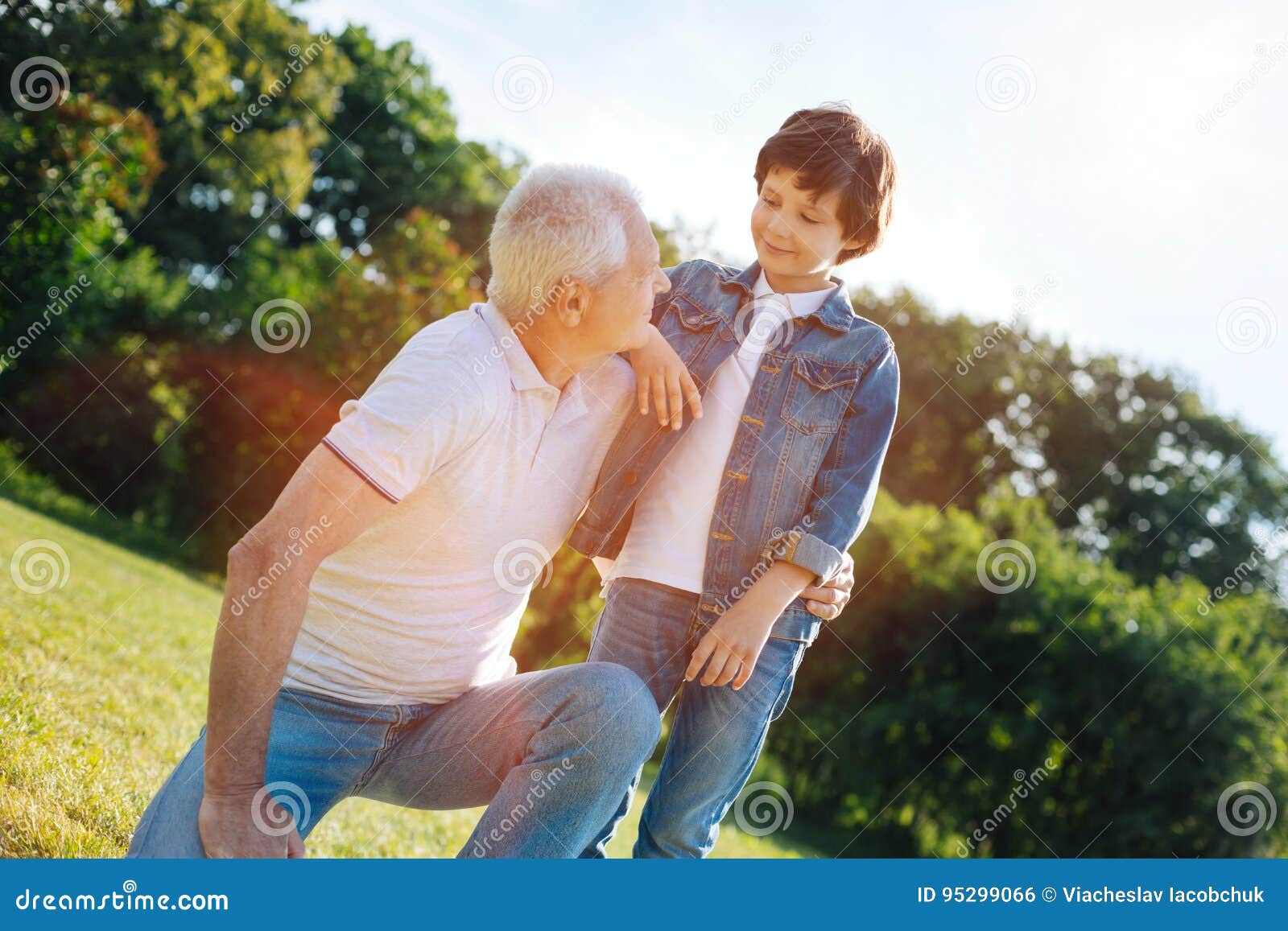 Charming Wise Man Talking To His Grandson Stock Photo - Image of family