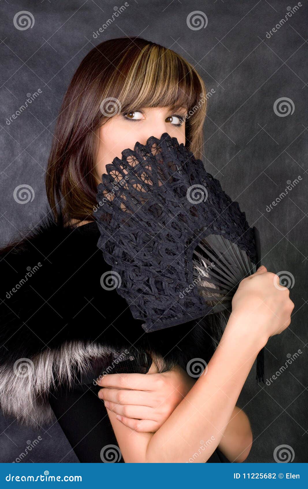 Charming woman. Charming young woman with italian fan. Fashion studio portrait