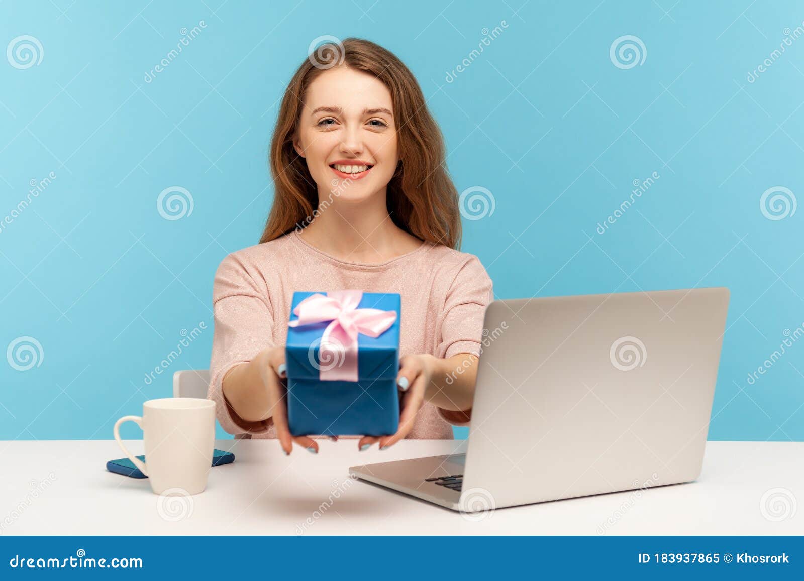 Charming Woman Employee Sitting at Workplace with Laptop and Holding ...