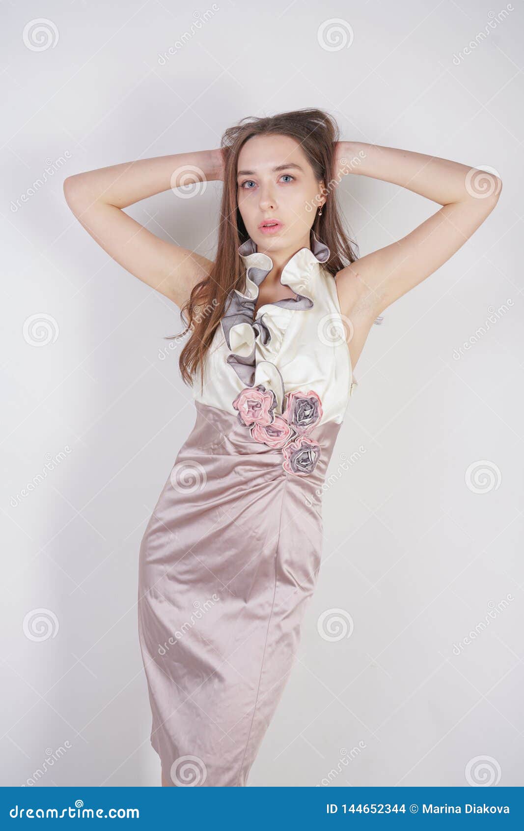 A Charming Young Caucasian Girl Stands in a Delicate Pale Short Prom ...