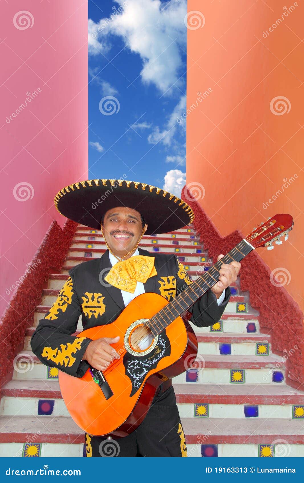 charro mariachi playing guitar in mexico stairway