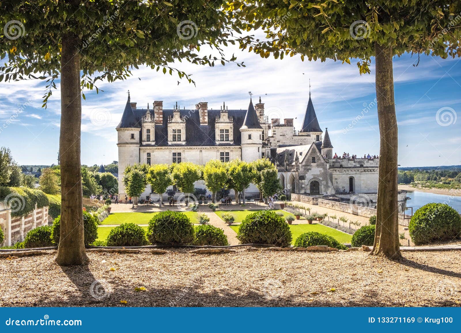 chateau amboise framed by trees of beautiful renaissance garden. loire valley, france
