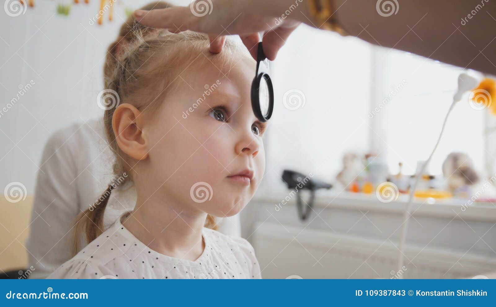 check up of eyesight in child`s ophthalmology - optometrist diagnosis little girl