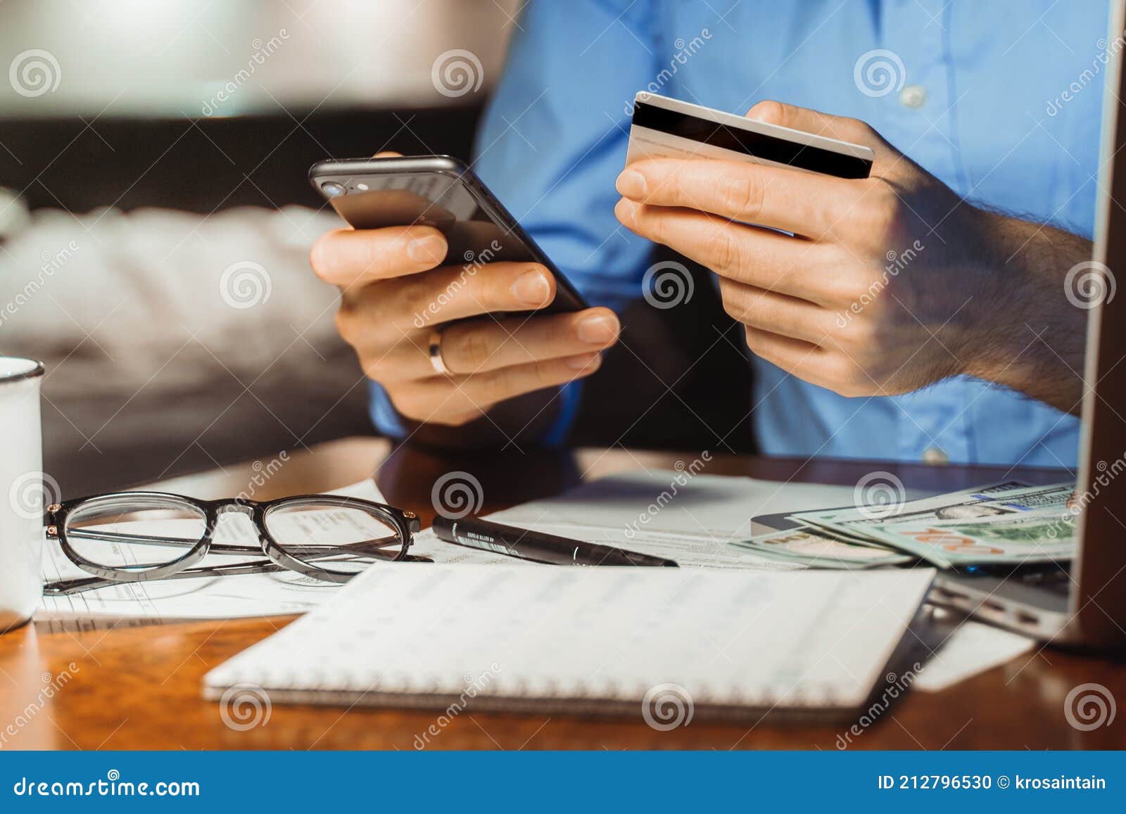 checking bank account balance credit card payment, income at home night. cropped shot male hands paying bill online on smartphone