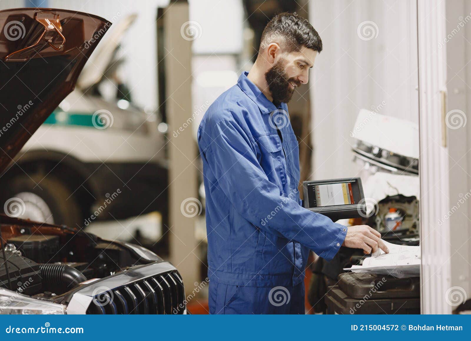 Checking Car for Serviceability in Garage with Tools on Rise Stock