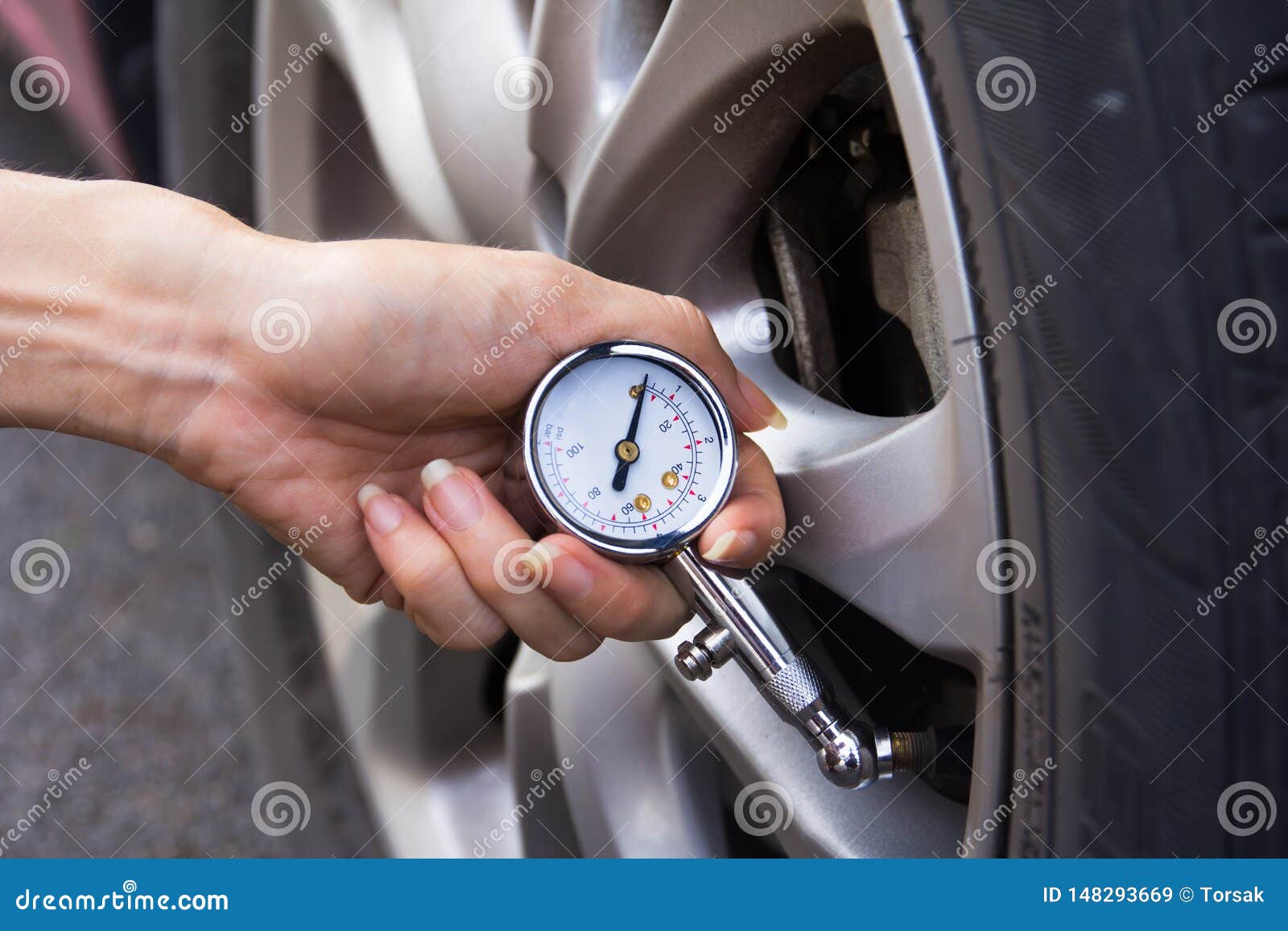 Checking car tyre pressure stock image. Image of wheel 148293669
