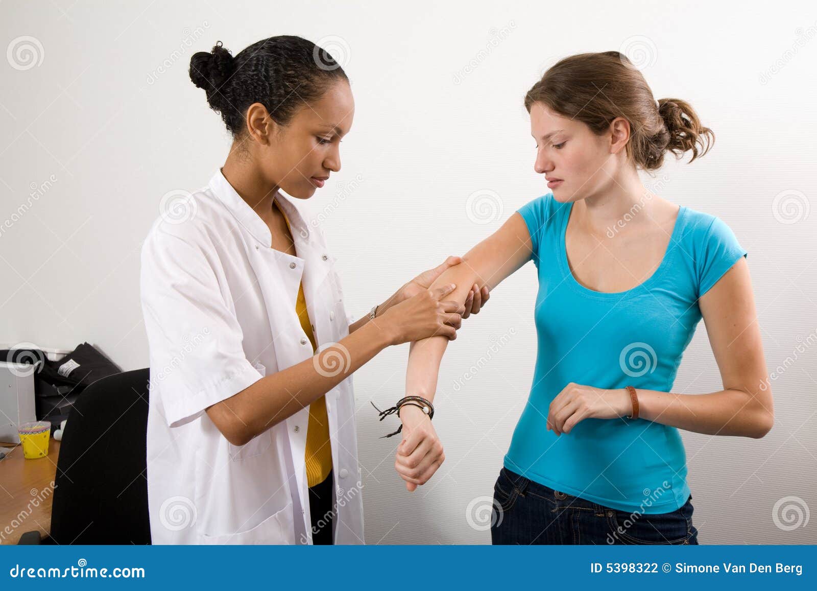 Checking her patient s arm stock photo. Image of consulting 5398322