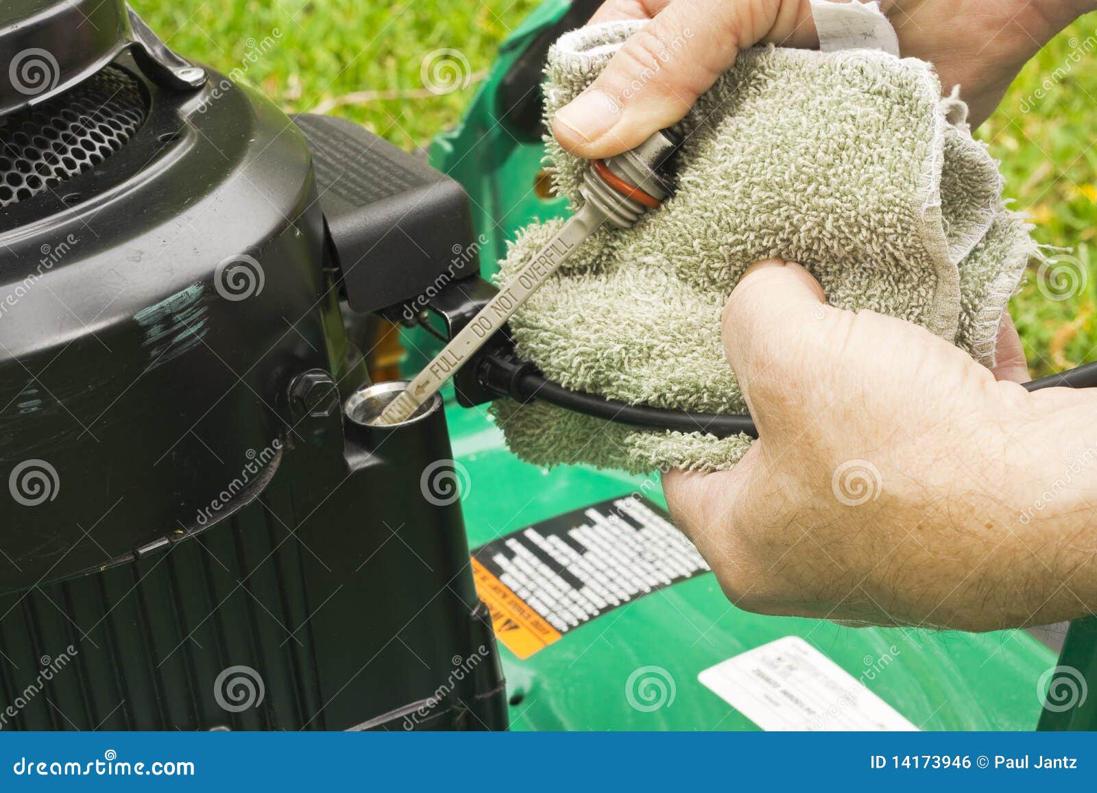 Checking Oil On A Lawn Mower Royalty Free Stock Image - Image: 14173946