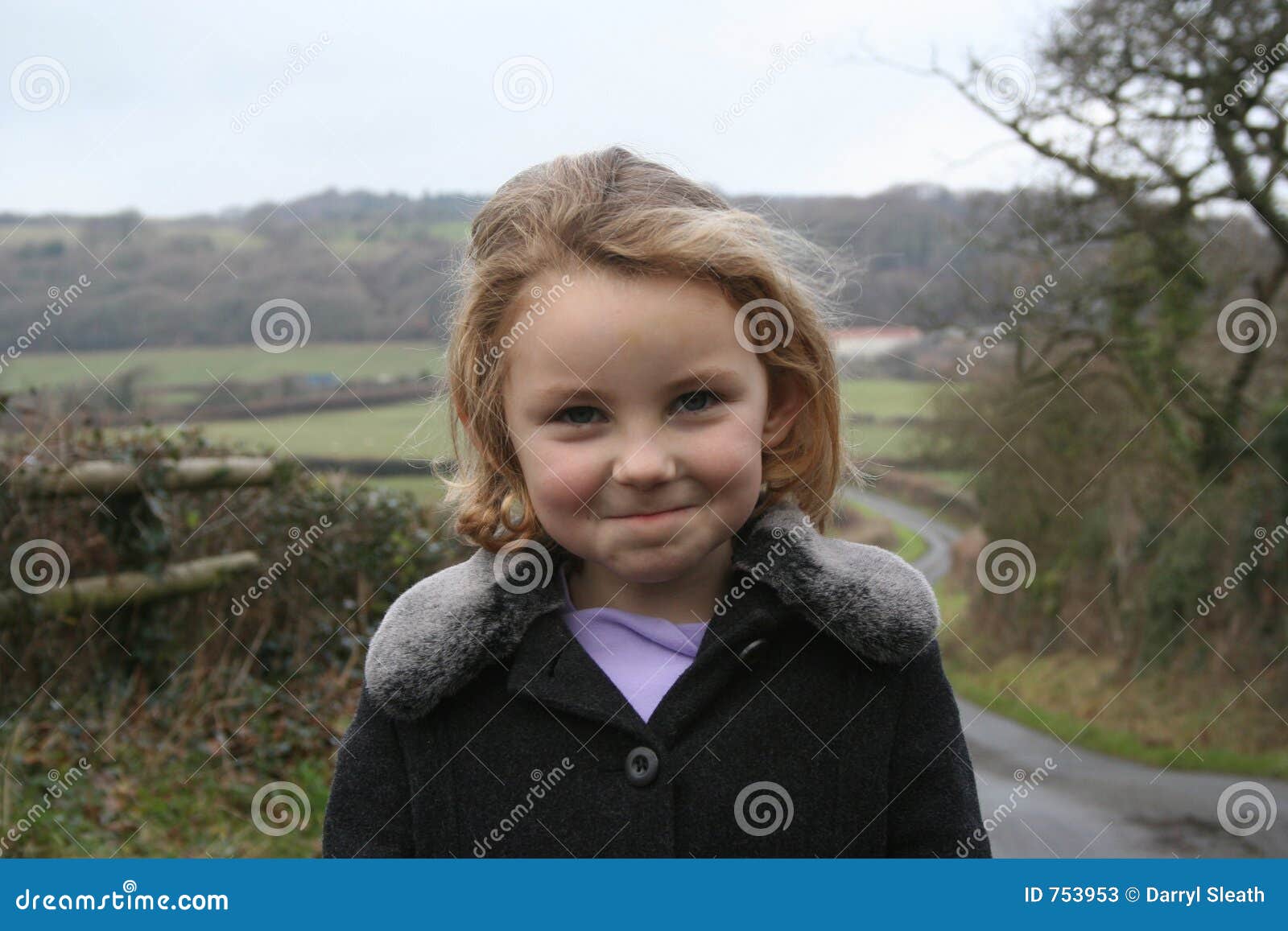 cheeky looking girl on country walk