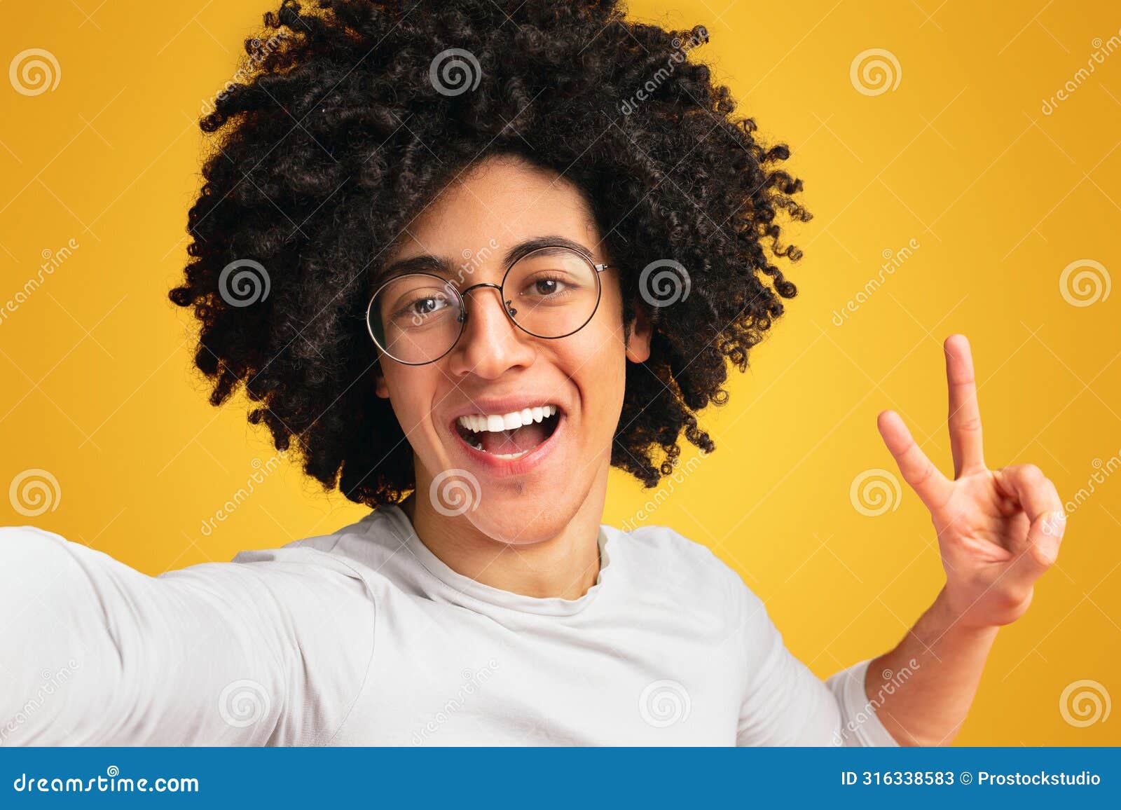 cheerful african american guy gesturing v sign on camera