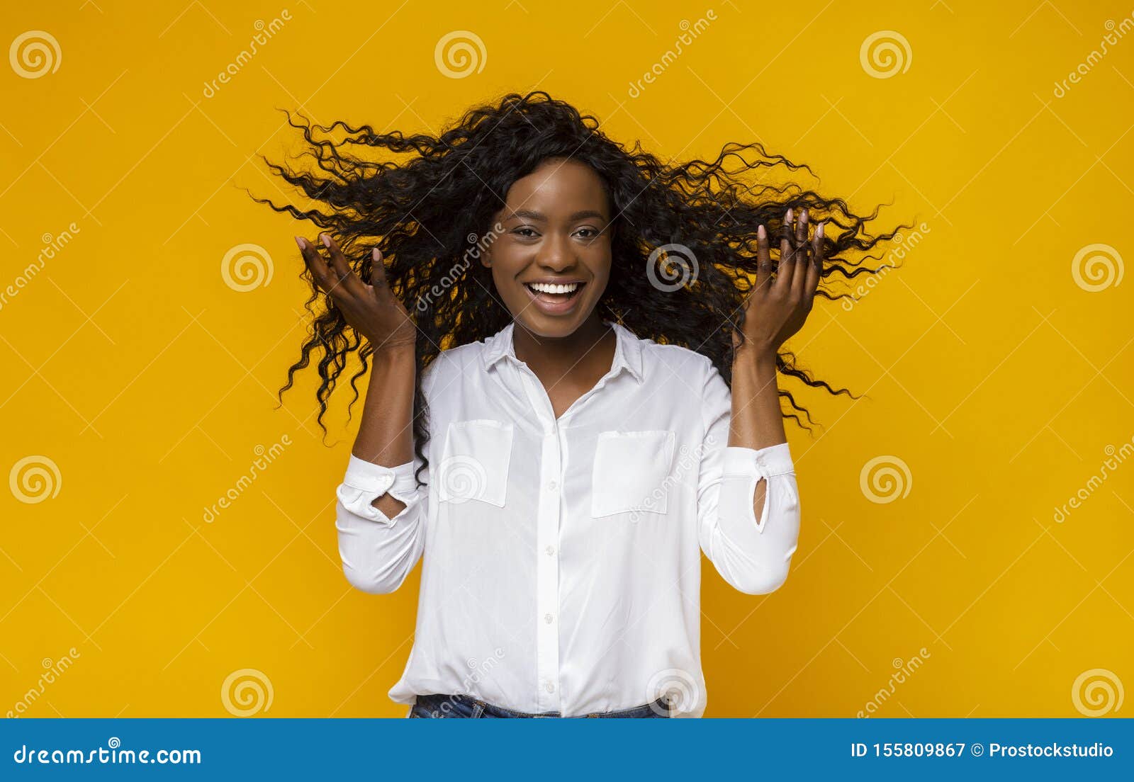 Cheerful African American Young Girl With Flying Curly Hair