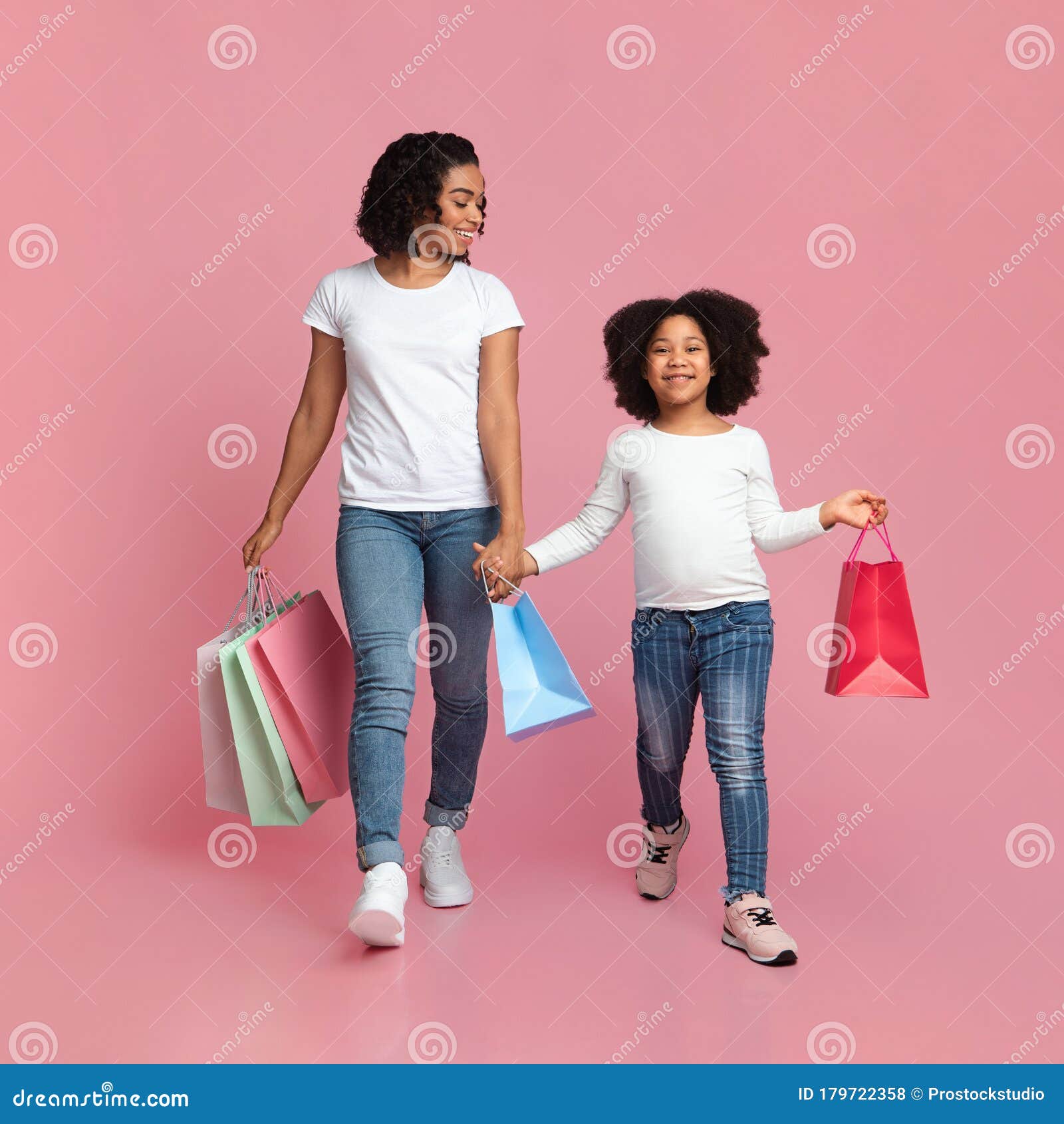 Cheerful African Mother and Daughter Walking with Shopper Bags and ...