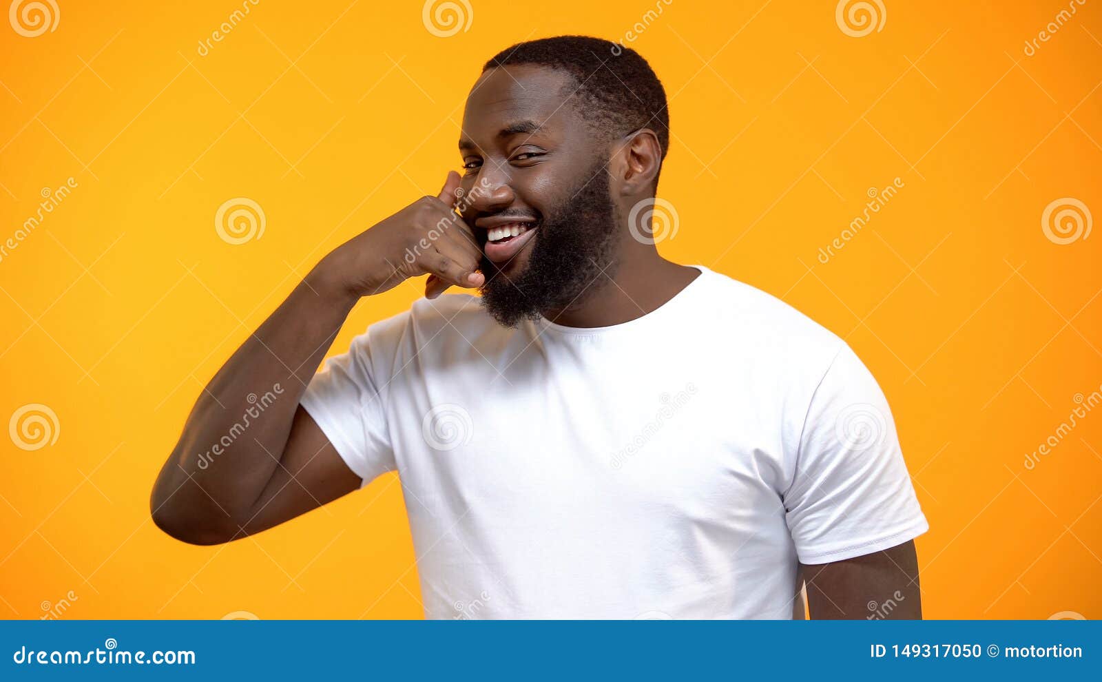 cheerful afro-american man showing call me gesture, getting acquainted on party