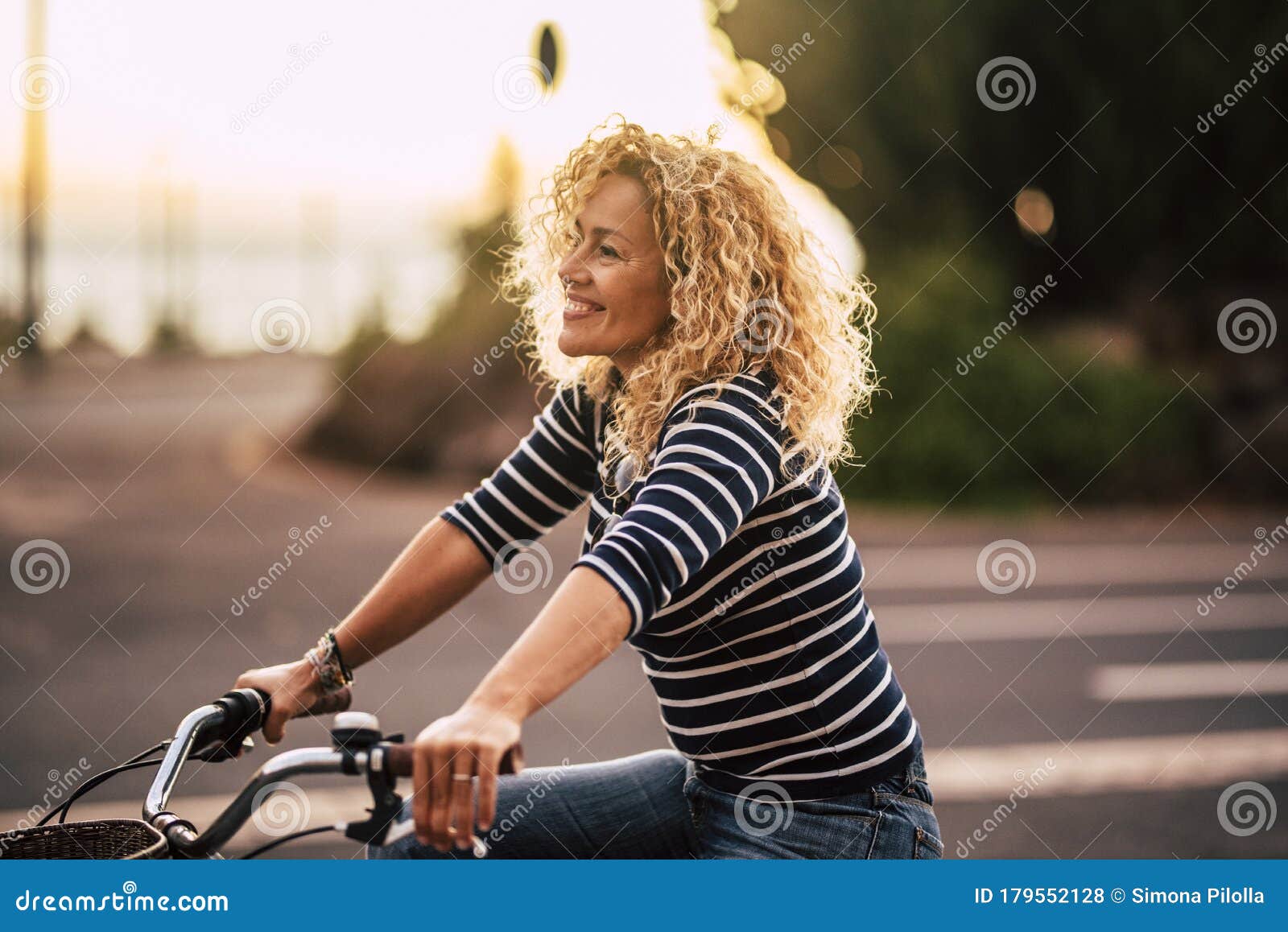 Cheerful Beauiful Blonde Curly Caucasian Woman Smile And Enjoy The Ride