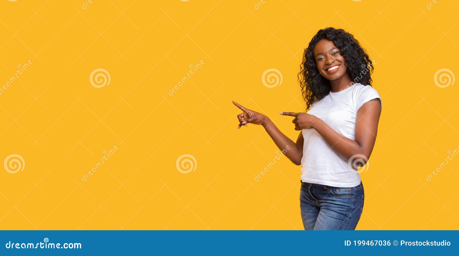 cheerful black lady pointing at copy space on yellow