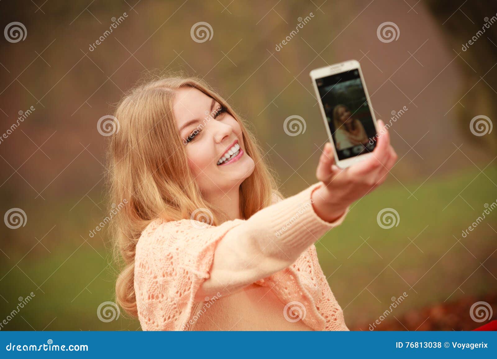 Blonde girl taking a selfie with her hair down - wide 4