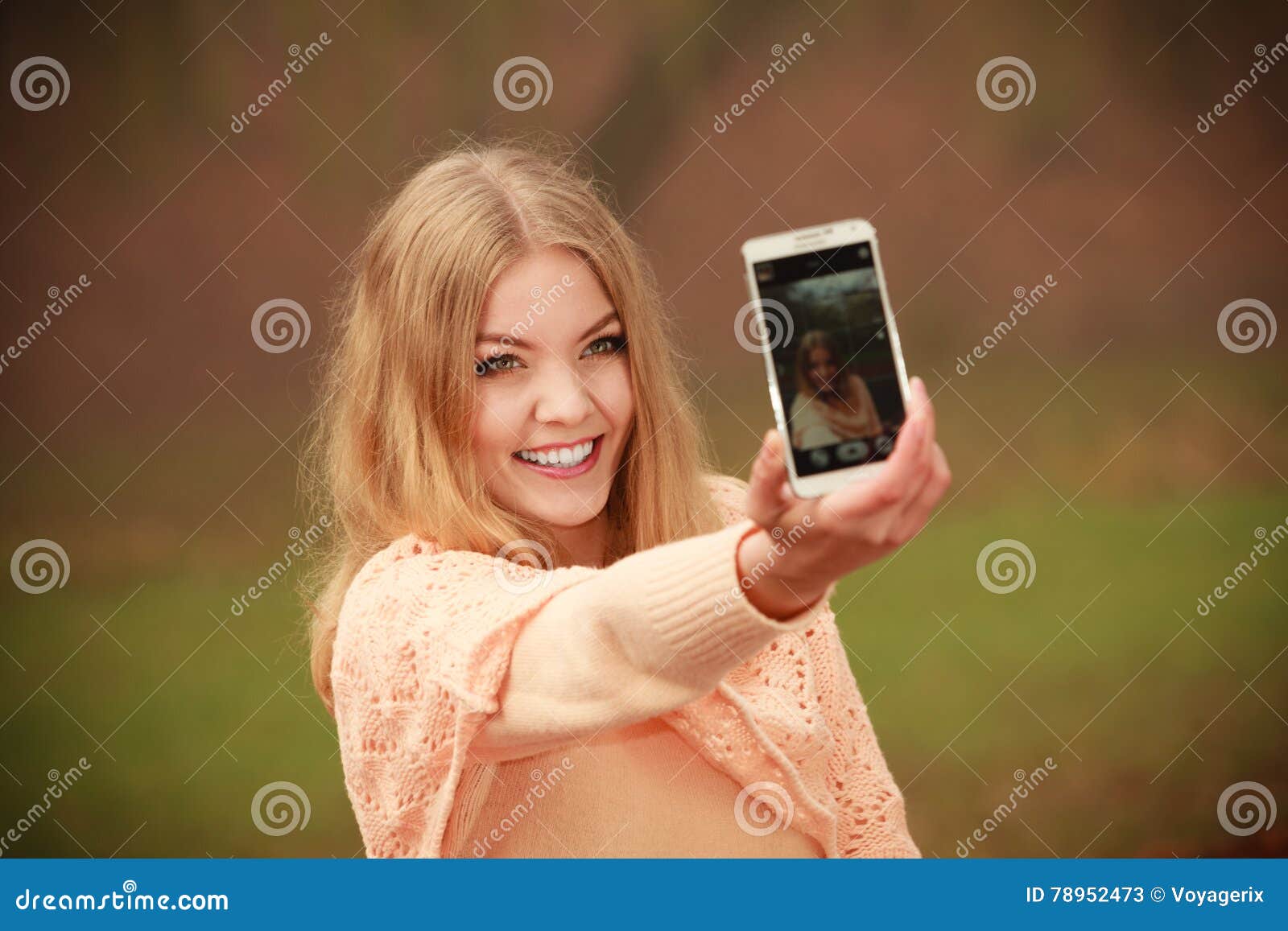Blonde girl taking a selfie with her hair down - wide 2