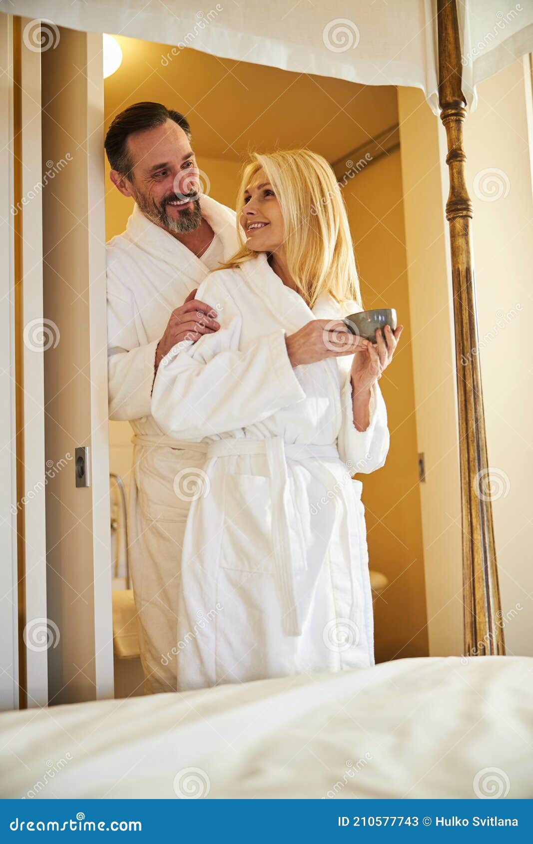 Joyful Couple in Cozy Bath-robes Posing in the Doorway Stock Image - Image  of generation, person: 210577743