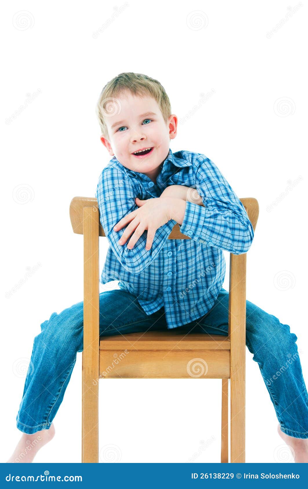 Cheerful Boy Sitting on a Chair Stock Image - Image of dark, child