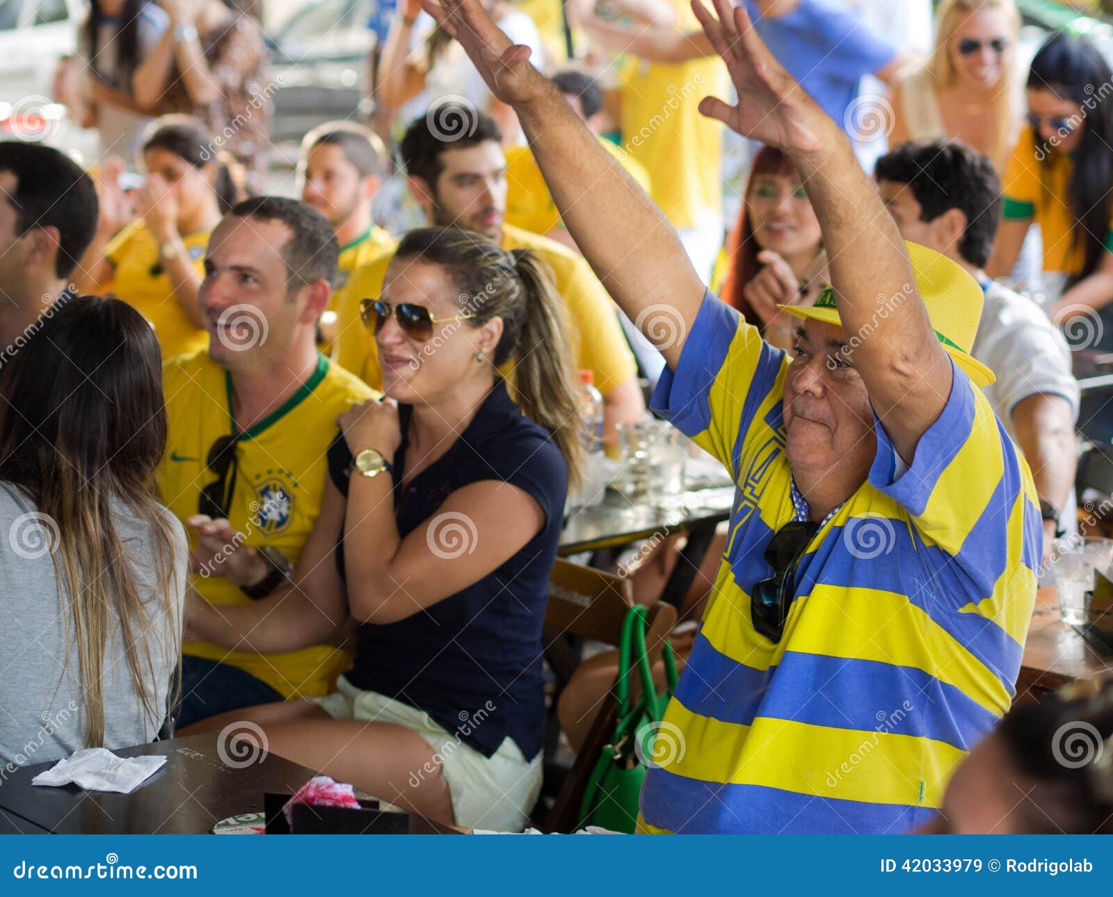 Cheerful Brazil Fans Watching World Cup Football Match on TV at a Bar Editorial Stock Image