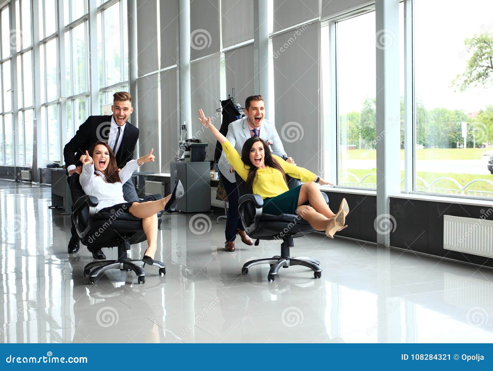 Cheerful Colleagues Having Fun In Office Chairs Stock Image