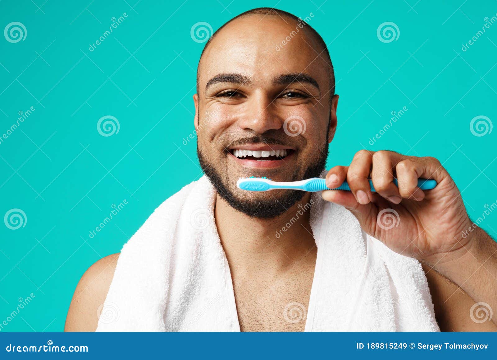 Cheerful Dark-skinned Male Brushing His Teeth Against Turquoise ...