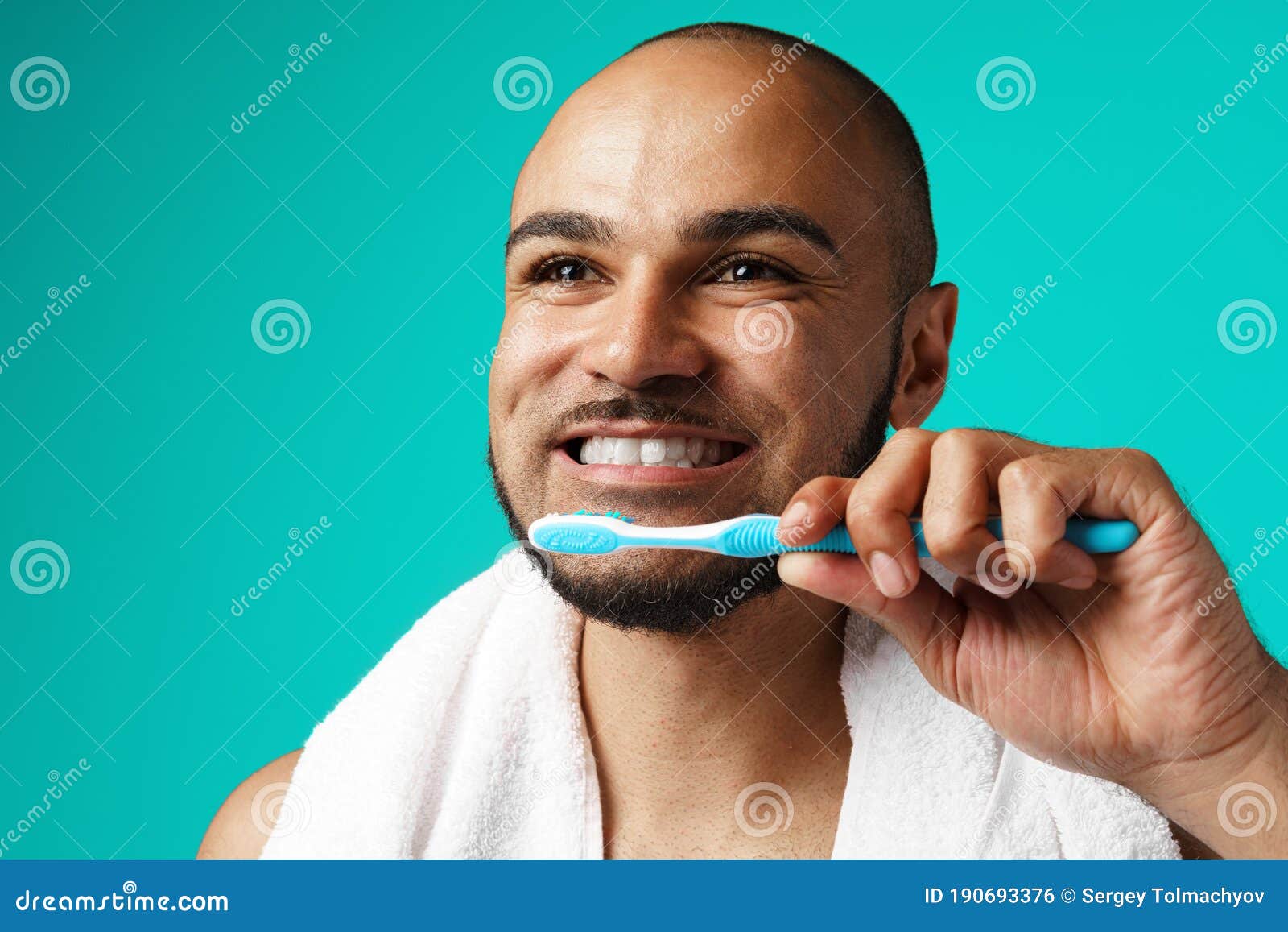 Cheerful Dark-skinned Male Brushing His Teeth Against Turquoise ...
