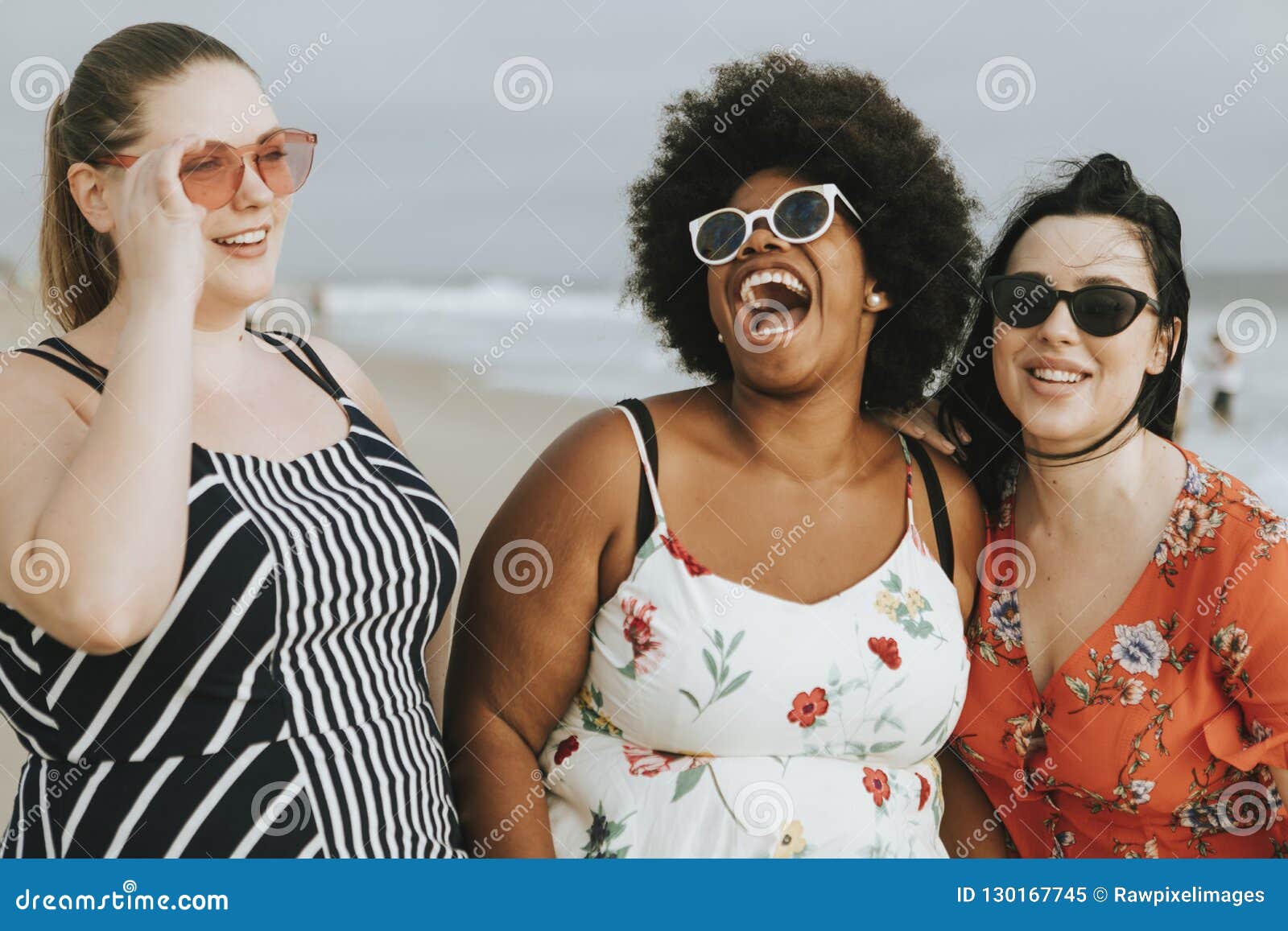 cheerful diverse plus size women at the beach