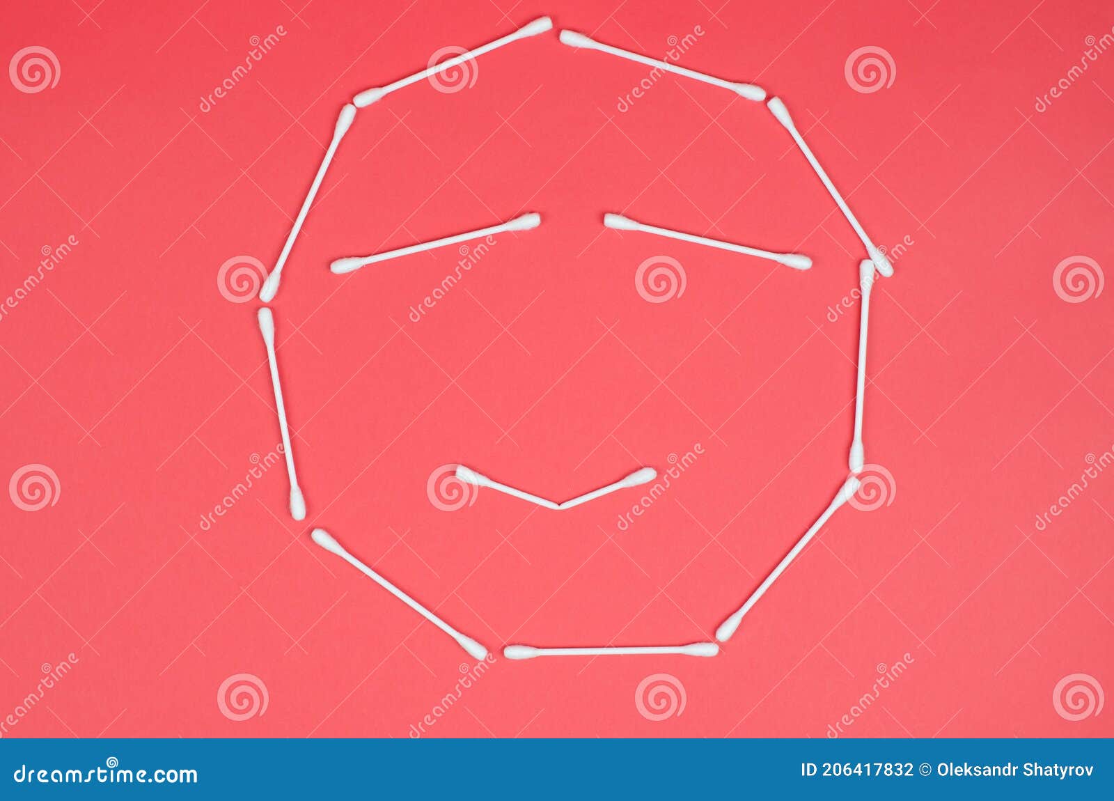 Cheerful Emoticon Made from Cotton Swabs on a Pink Background Stock