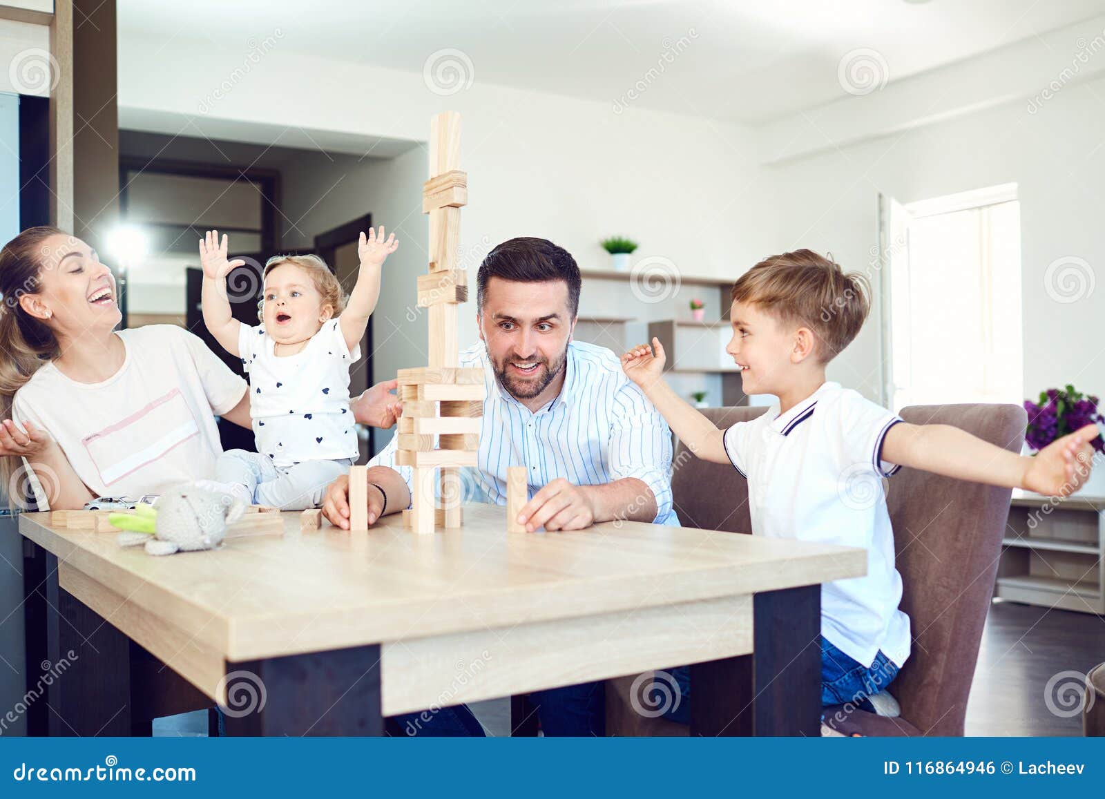 a family plays board games sitting at a table indoors.