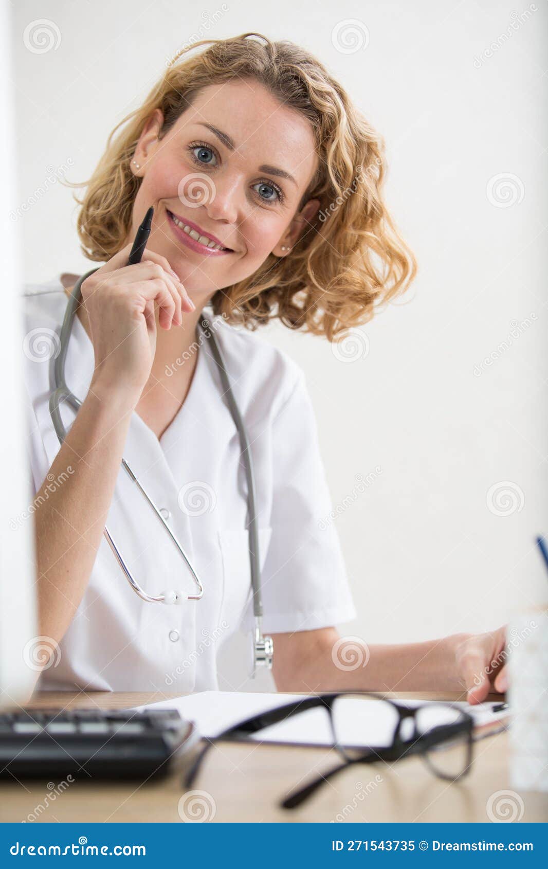cheerful female doctor sat at desk