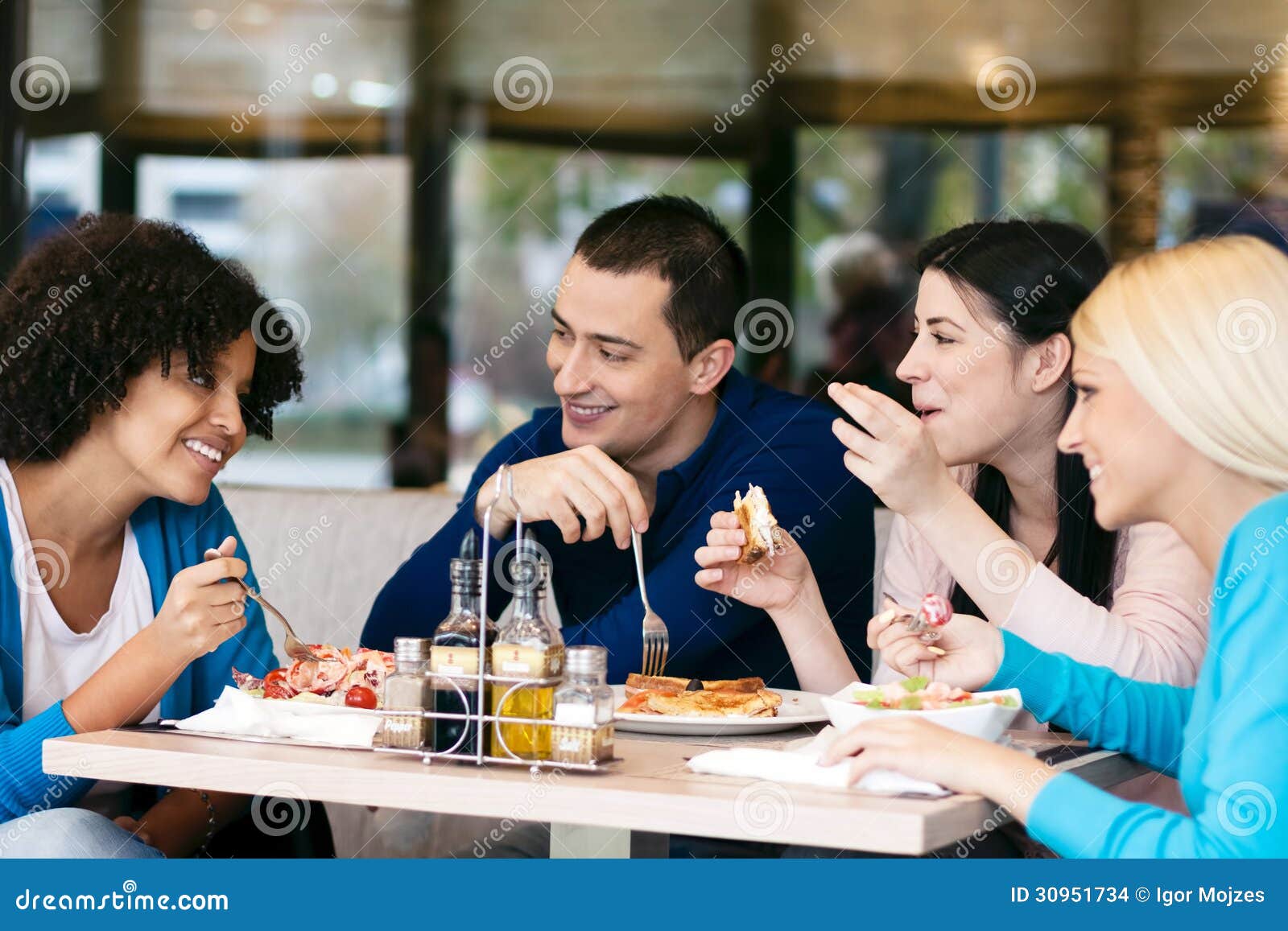 cheerful friends chatting while lunch