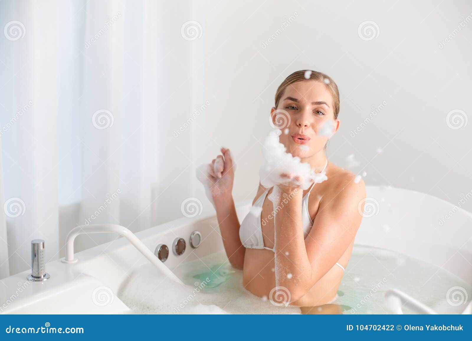 Young lass having fun in the bath