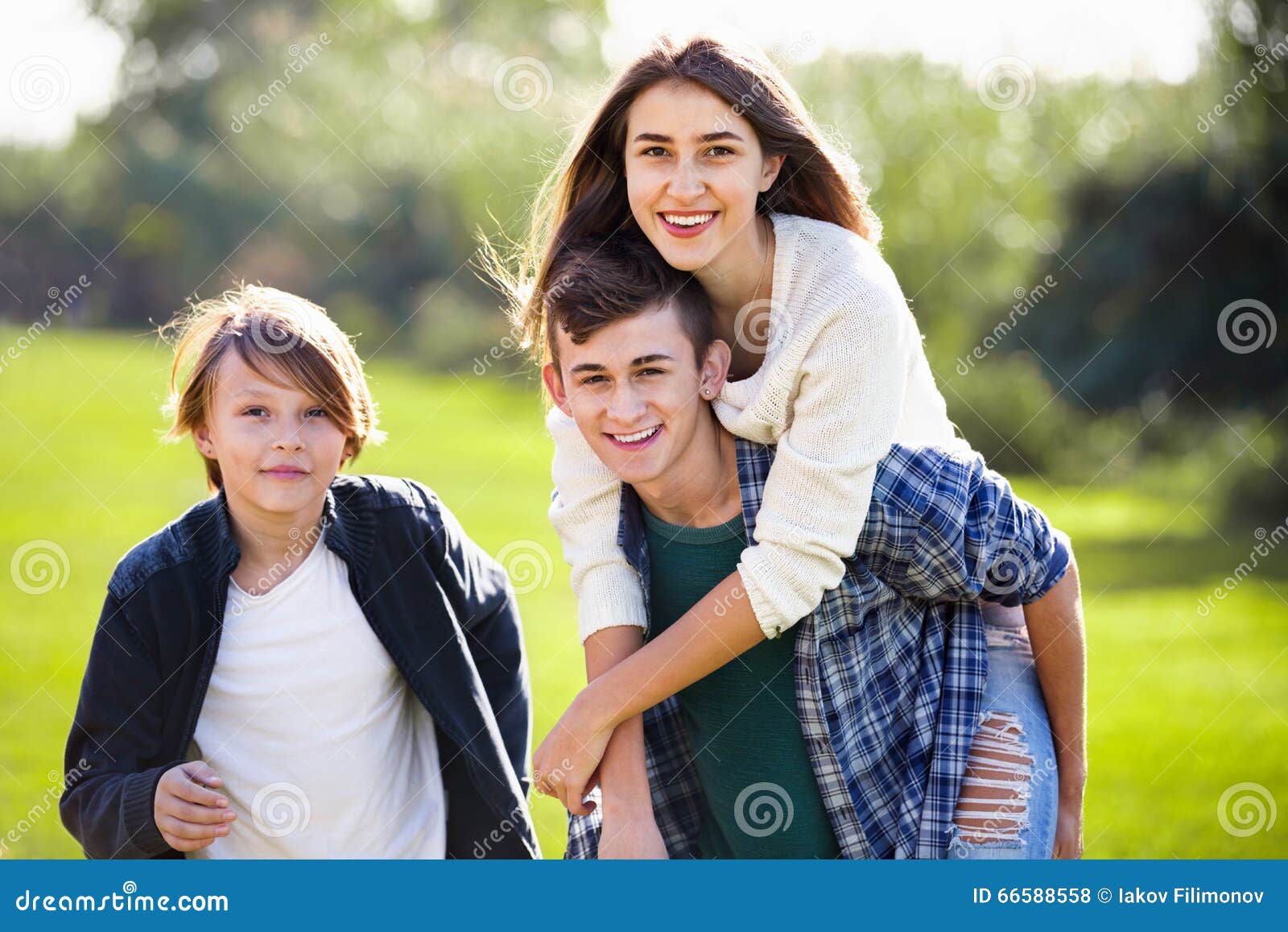 Cheerful Girl with Two Boys Posing in Fall Park Stock Photo - Image of ...