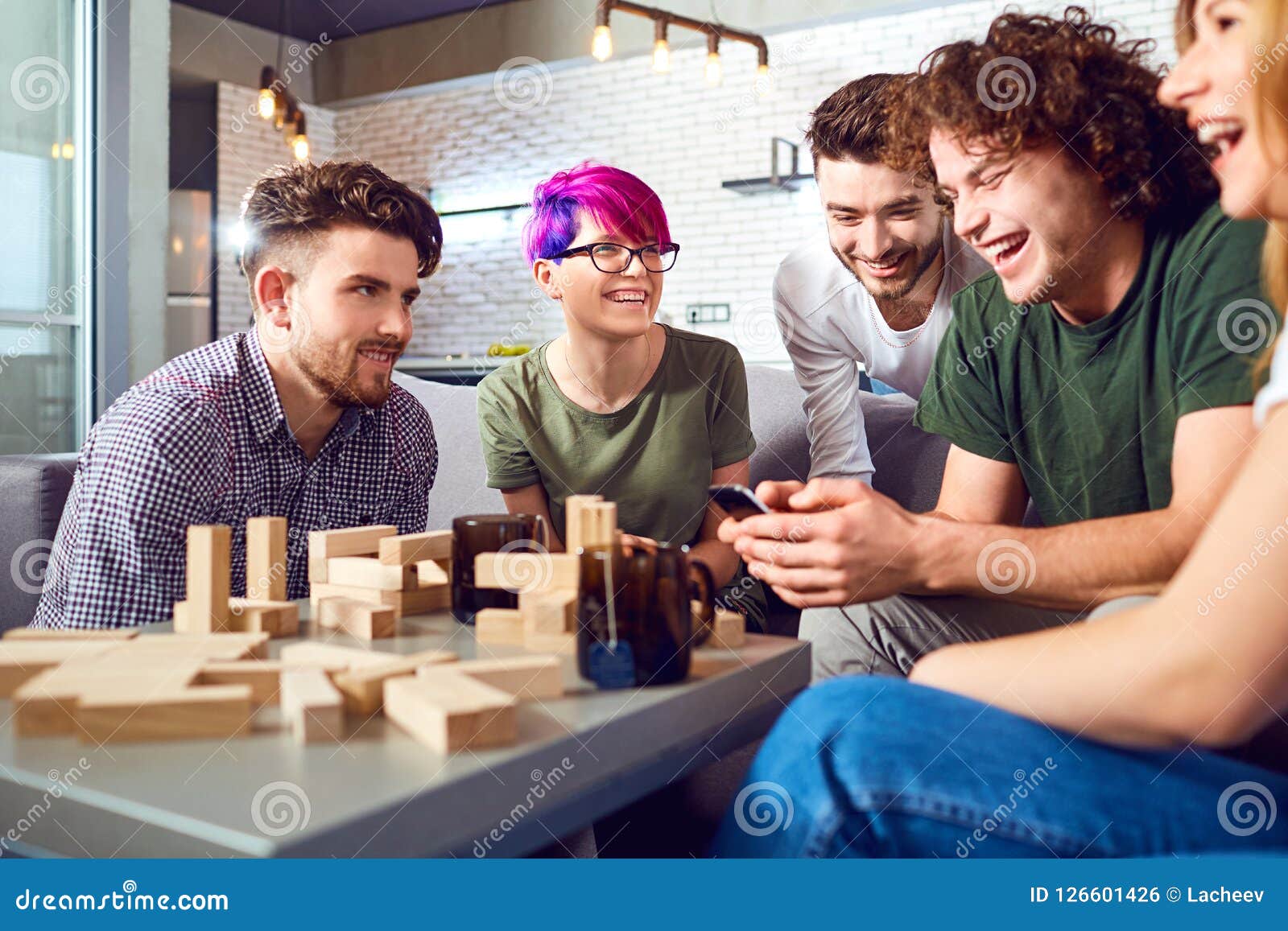 A Cheerful Group Of Friends Play Board Games Stock Photo Image Of