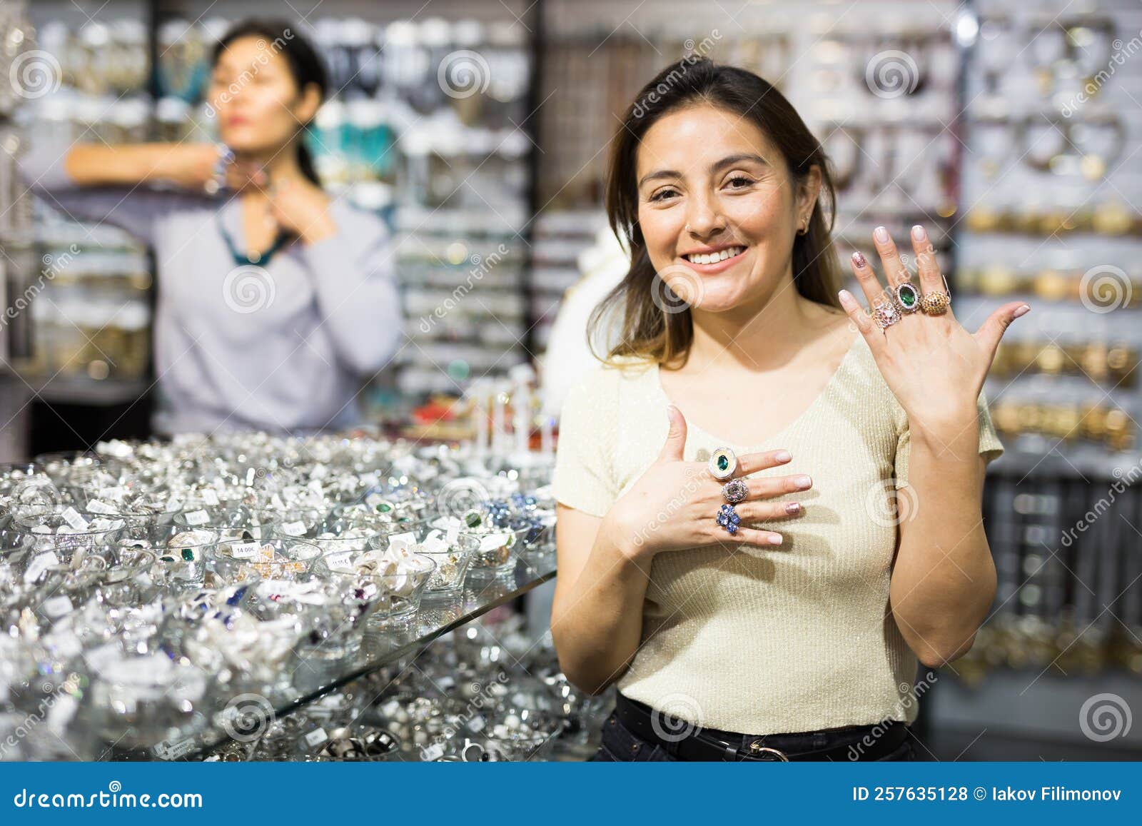 Cheerful Hispanic Girl Showing Rings on Fingers in Jewelry Showroom ...