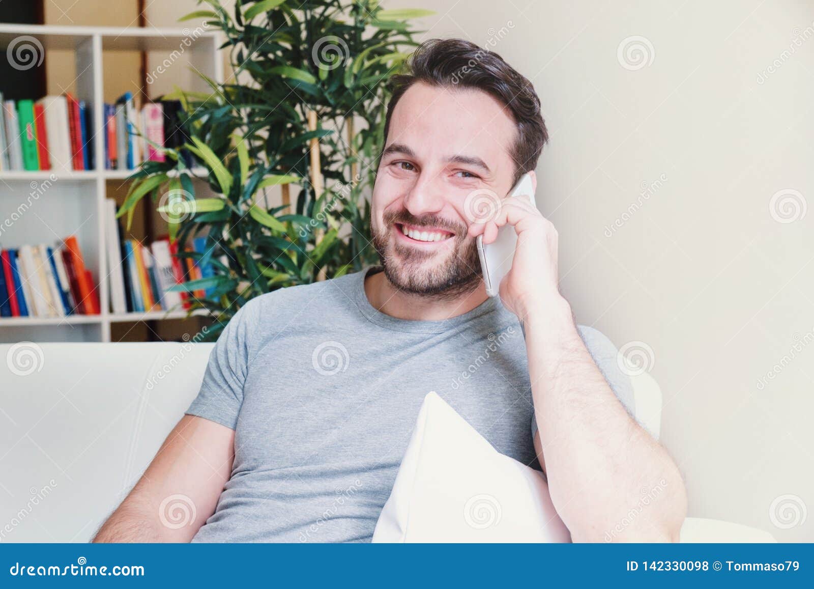 Cheerful Man Making a Phone Call at Home Stock Photo - Image of friends