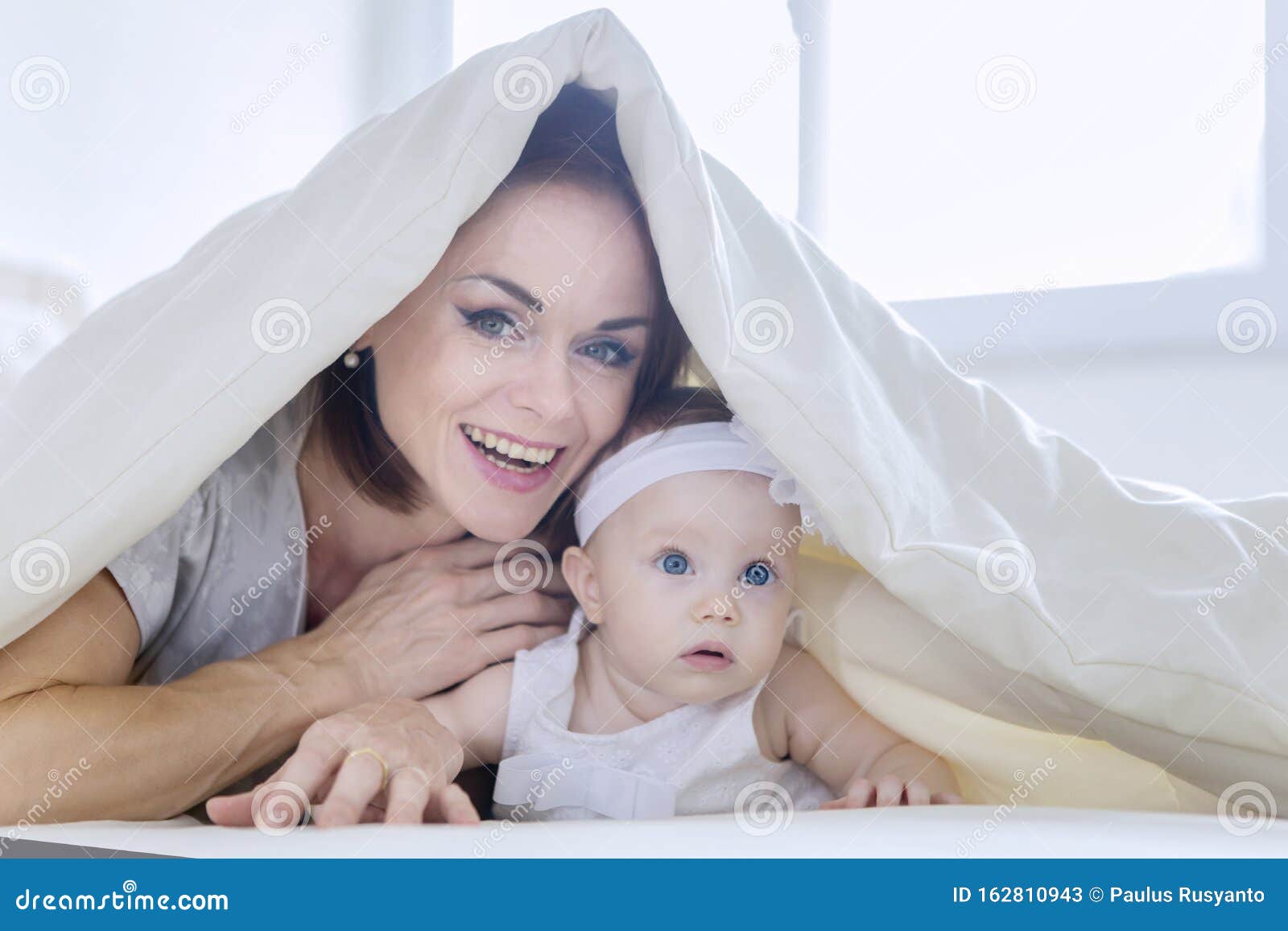 Cheerful Mother Plays with Her Baby Under a Blanket Stock Image - Image ...