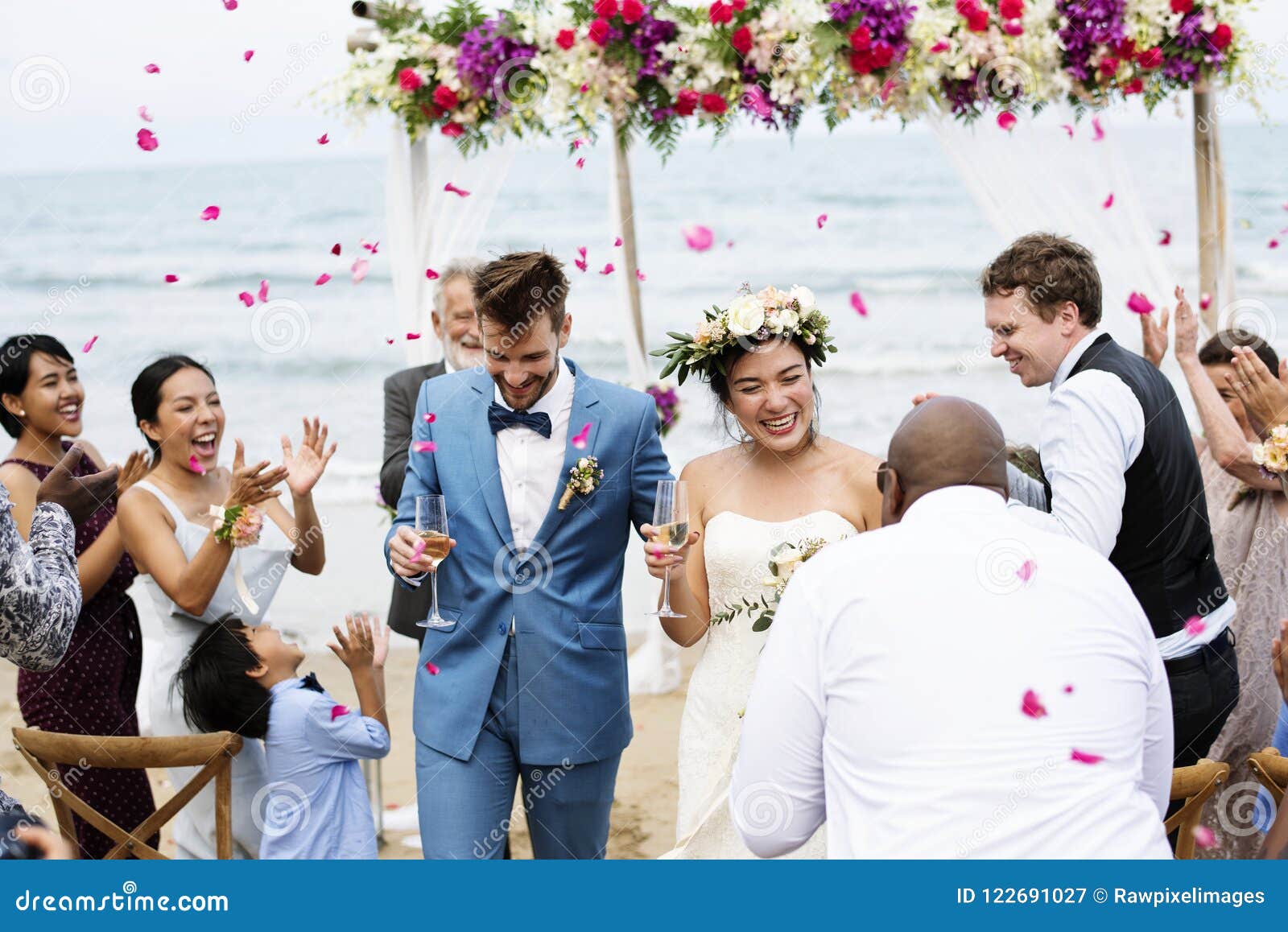 cheerful newlyweds at beach wedding ceremony