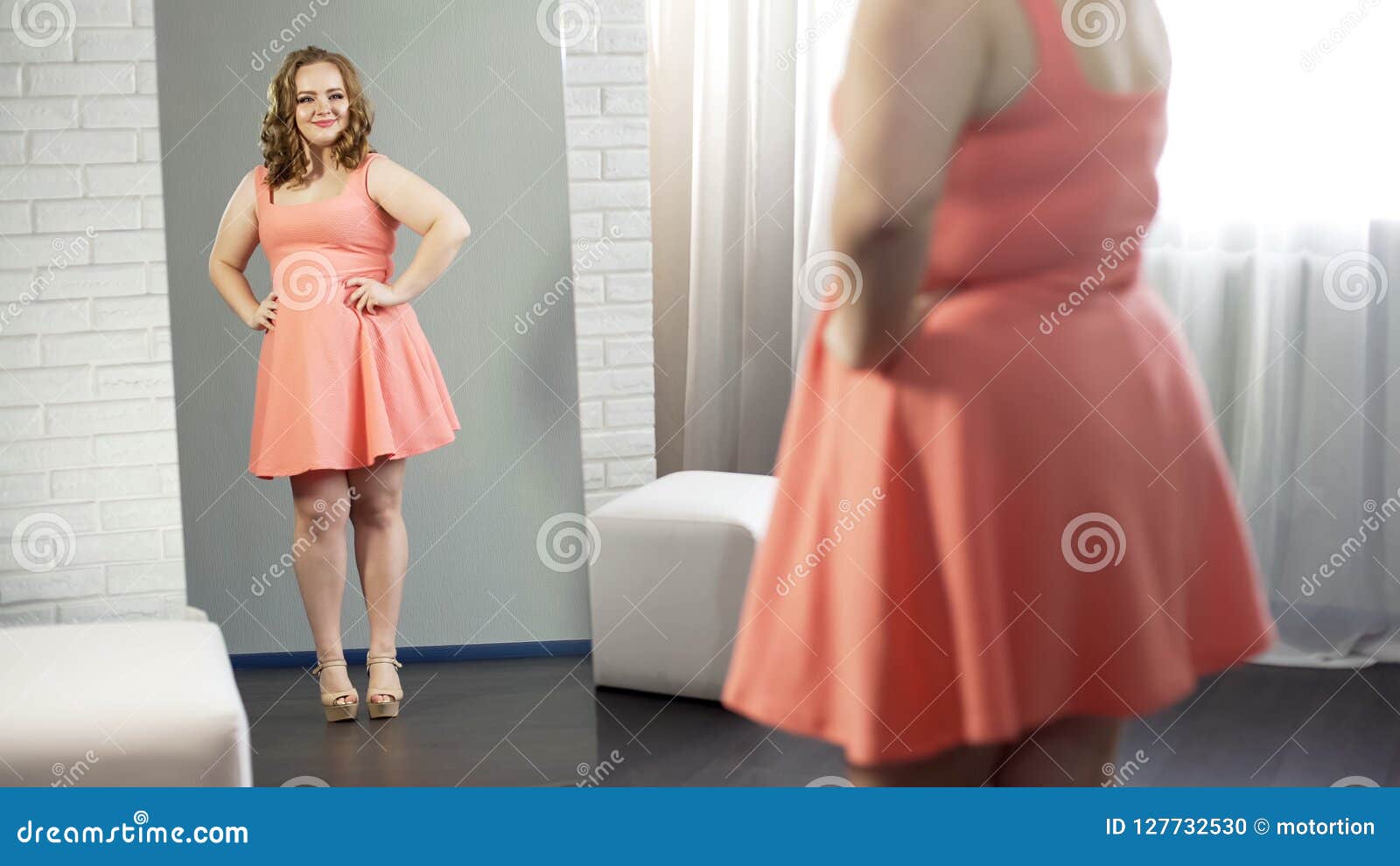 cheerful overweight young lady smiling at her reflection, body positivity
