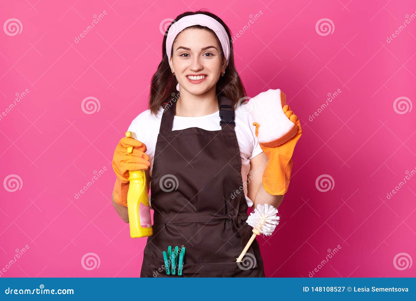 Cheerful Positive Cute Housewife Holding Washcloth And Detergent In