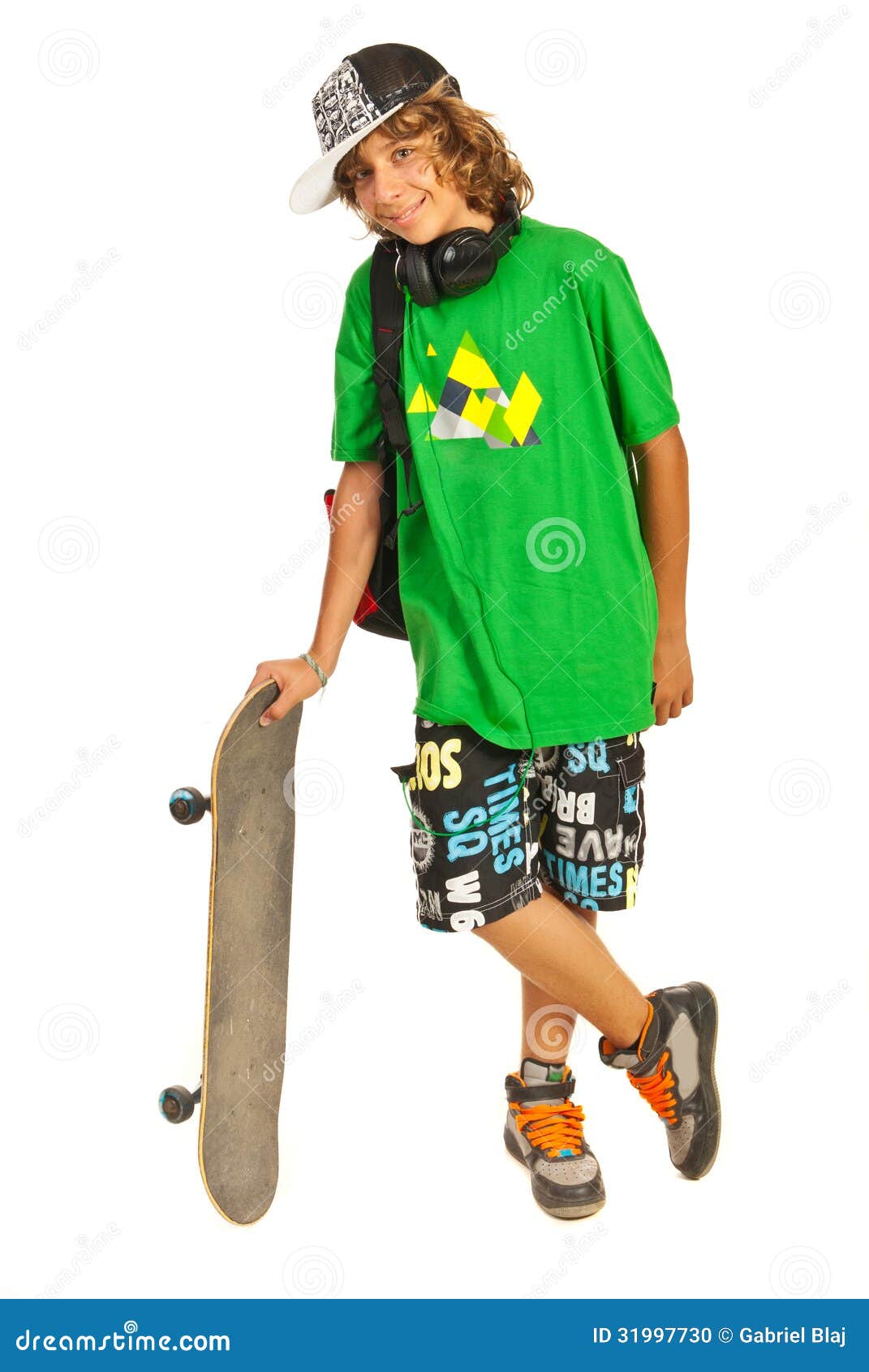 cheerful schoolboy teen with skateboard