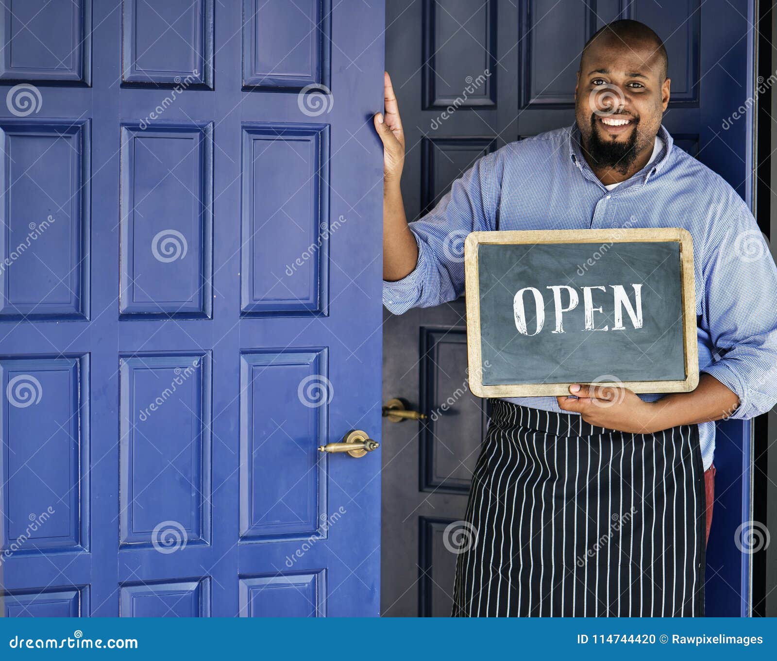 a cheerful small business owner with open sign
