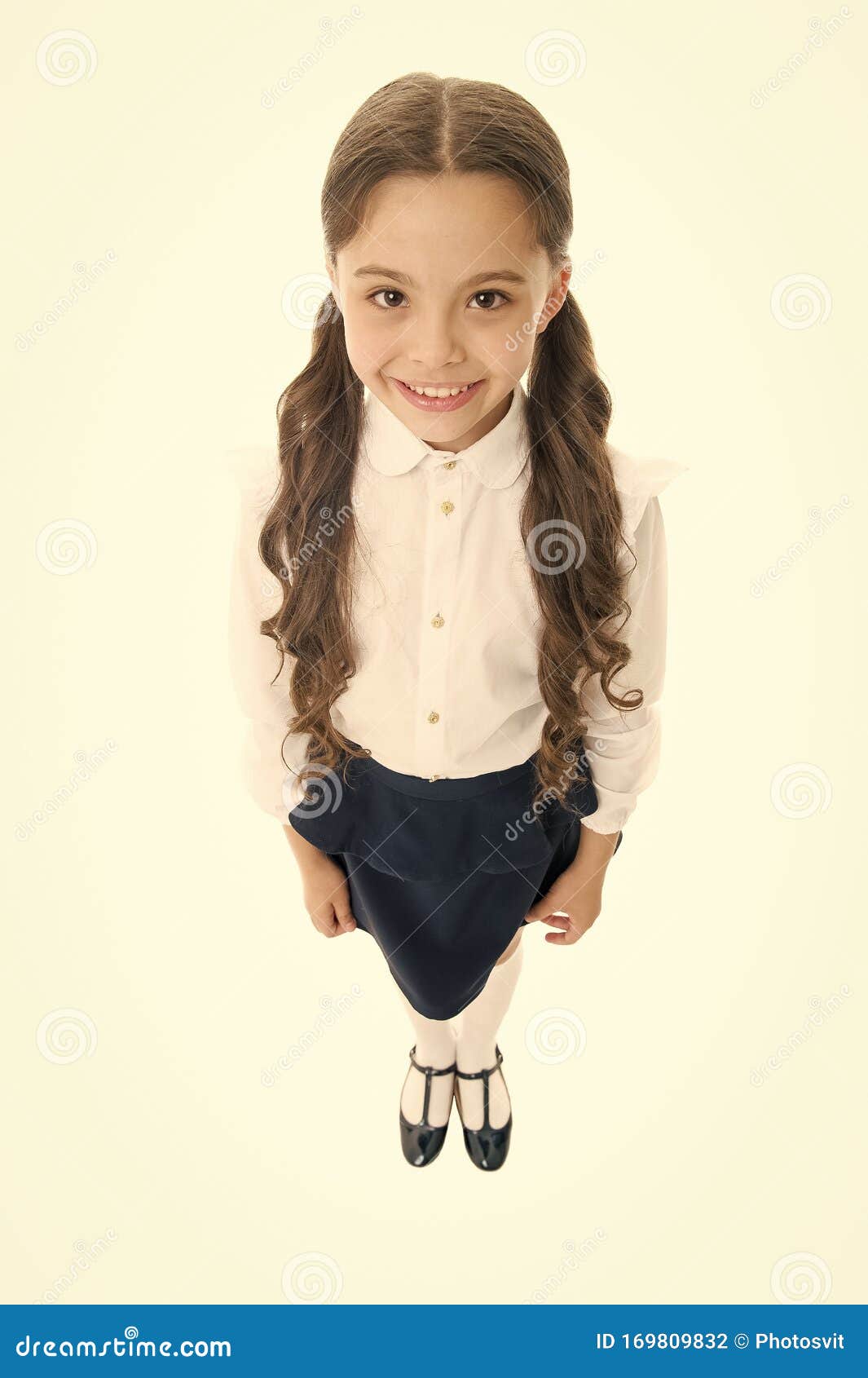 cheerful smile. girl cute pupil on white background. school uniform. back to school. student little kid adores school