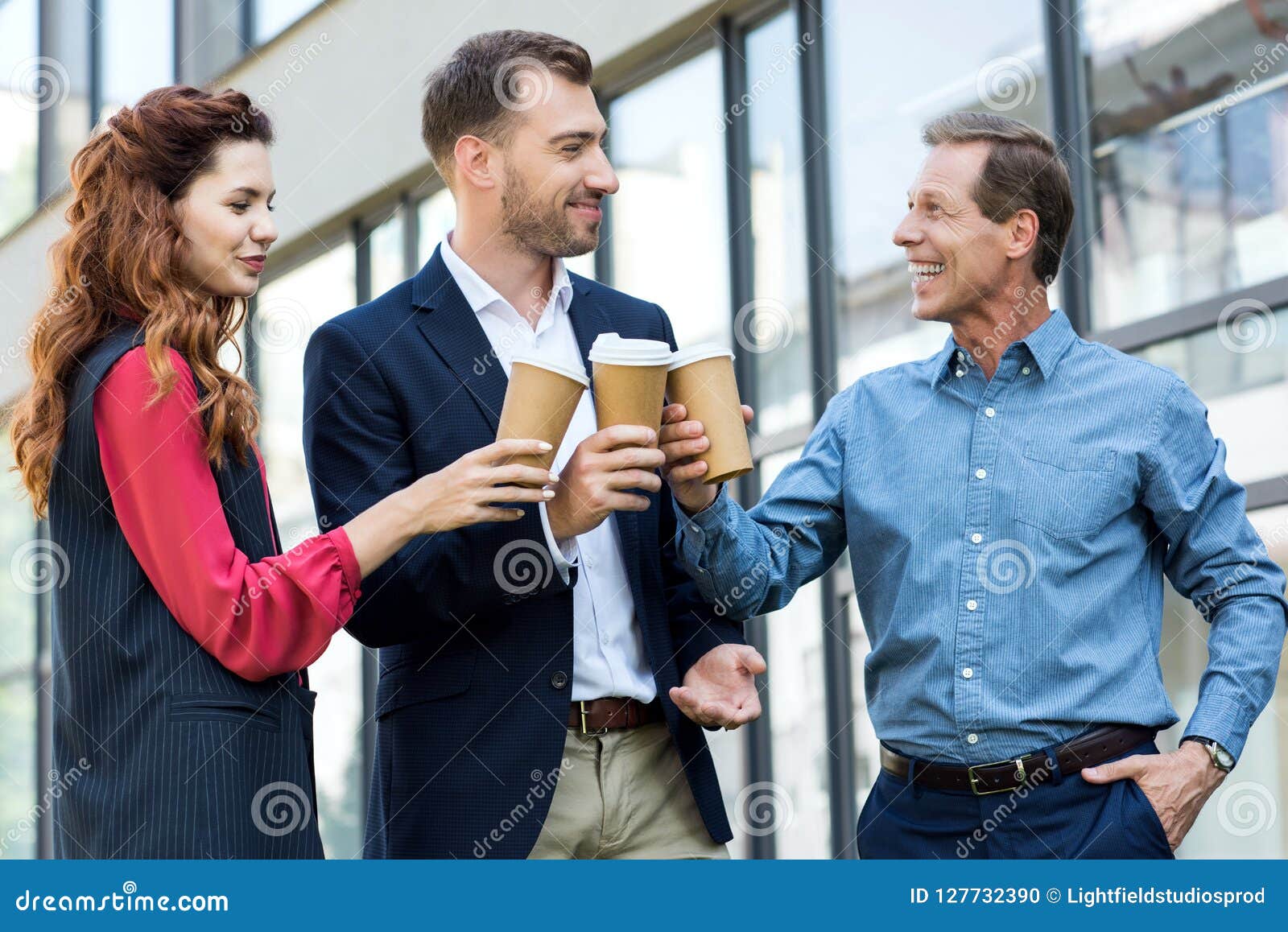 cheerful successful business team clinking with disposable cups