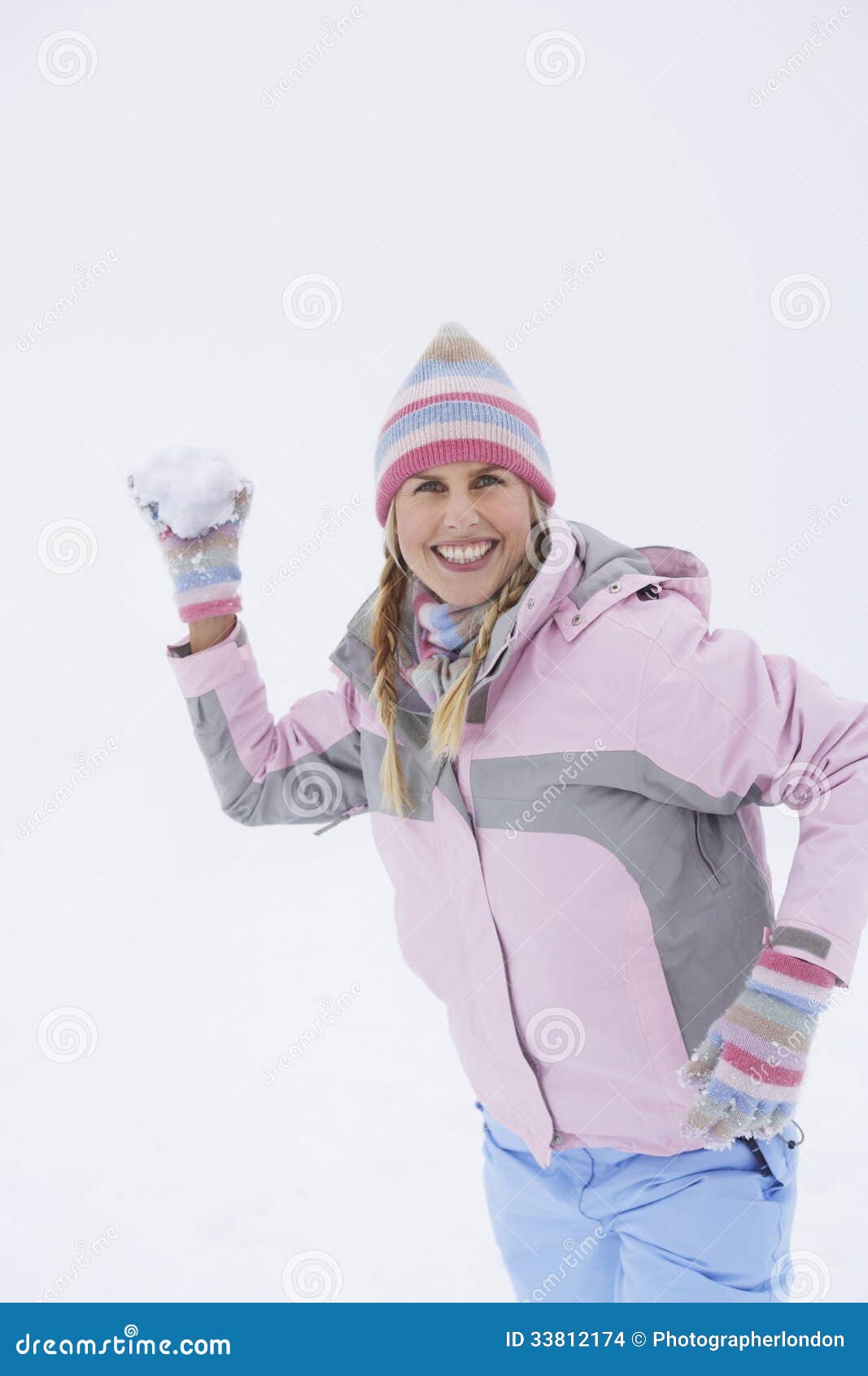 Cheerful Woman Throwing Snowball Stock Photo - Image of cheerful, snow ...