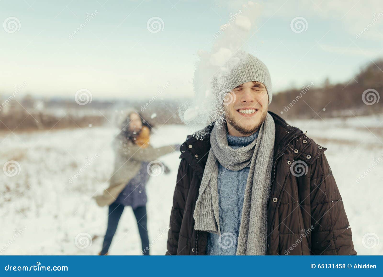 Cheerful Young Couple Playing Snowballs Stock Photo - Image of ...