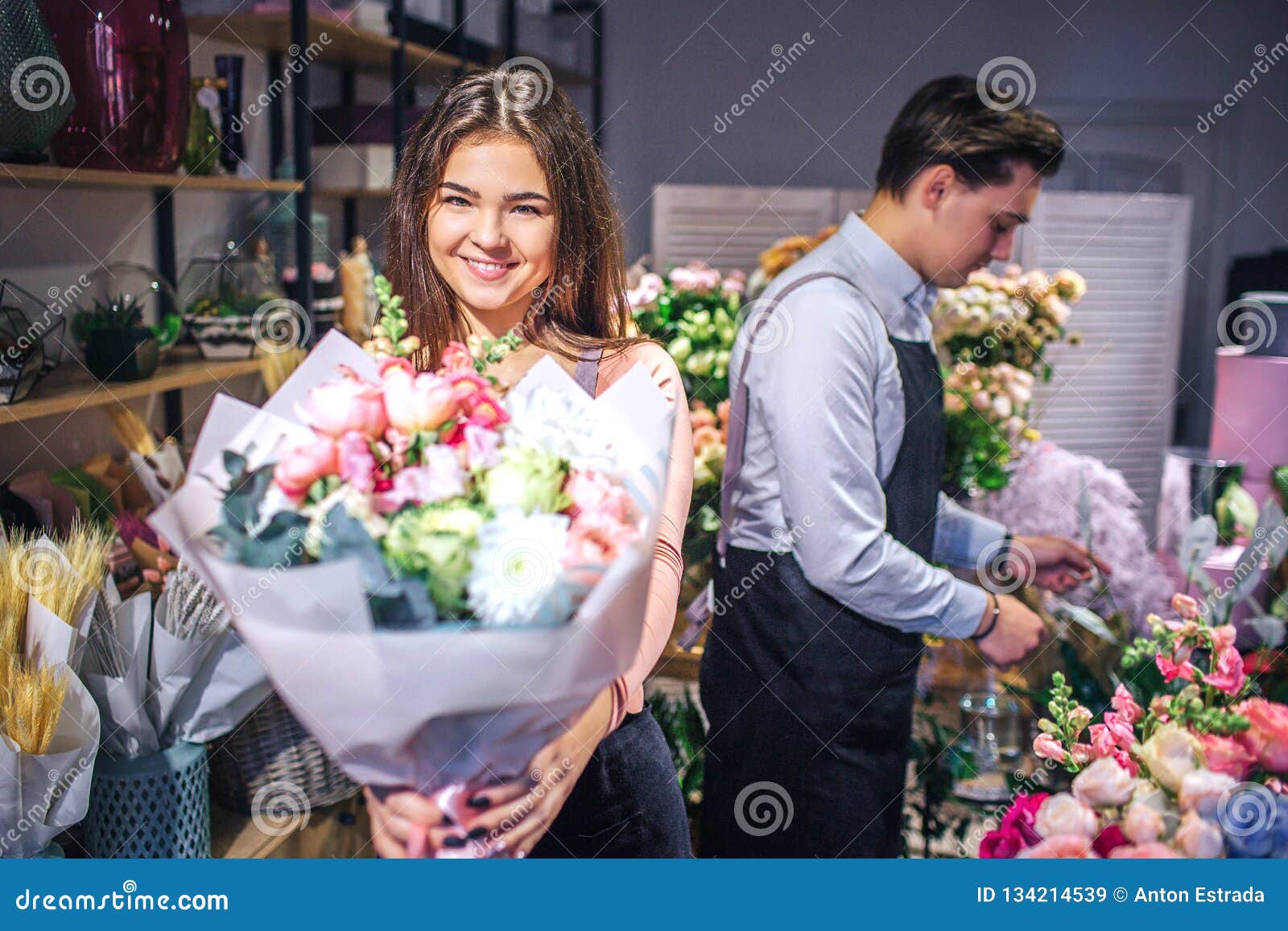 Cheerful Young Female Florist Look on Camera and Smile. she Hold ...