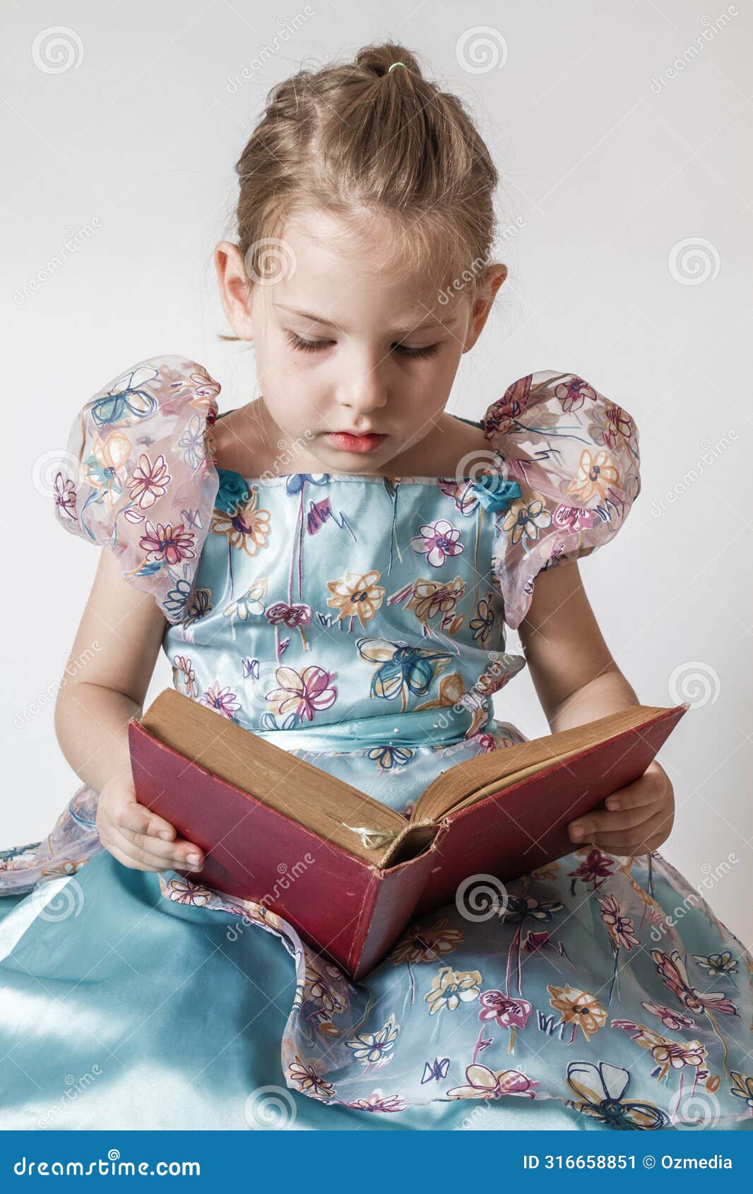 cheerful little girl engrossed in reading, embracing knowledge and education