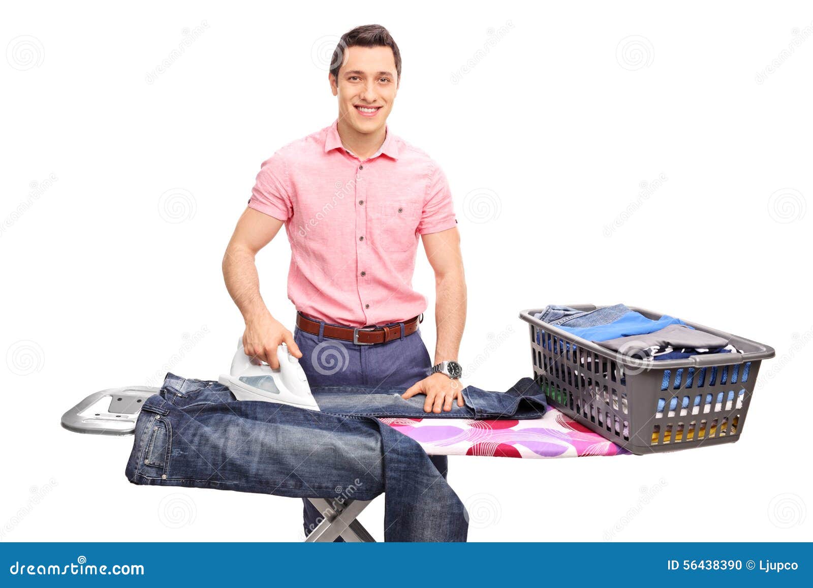 Cheerful Young Man Ironing a Pair of Jeans Stock Photo Image of